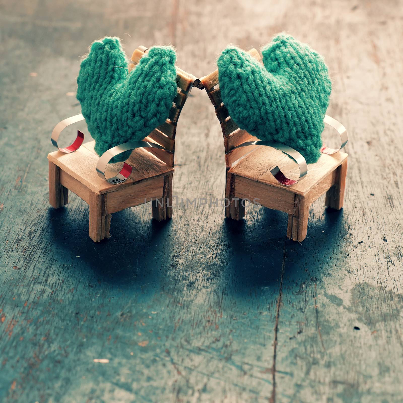 Two hearts be together, illustration for couple in love, take care and loving, green heart on handmade mini furniture as chair, swing, bed on wood background