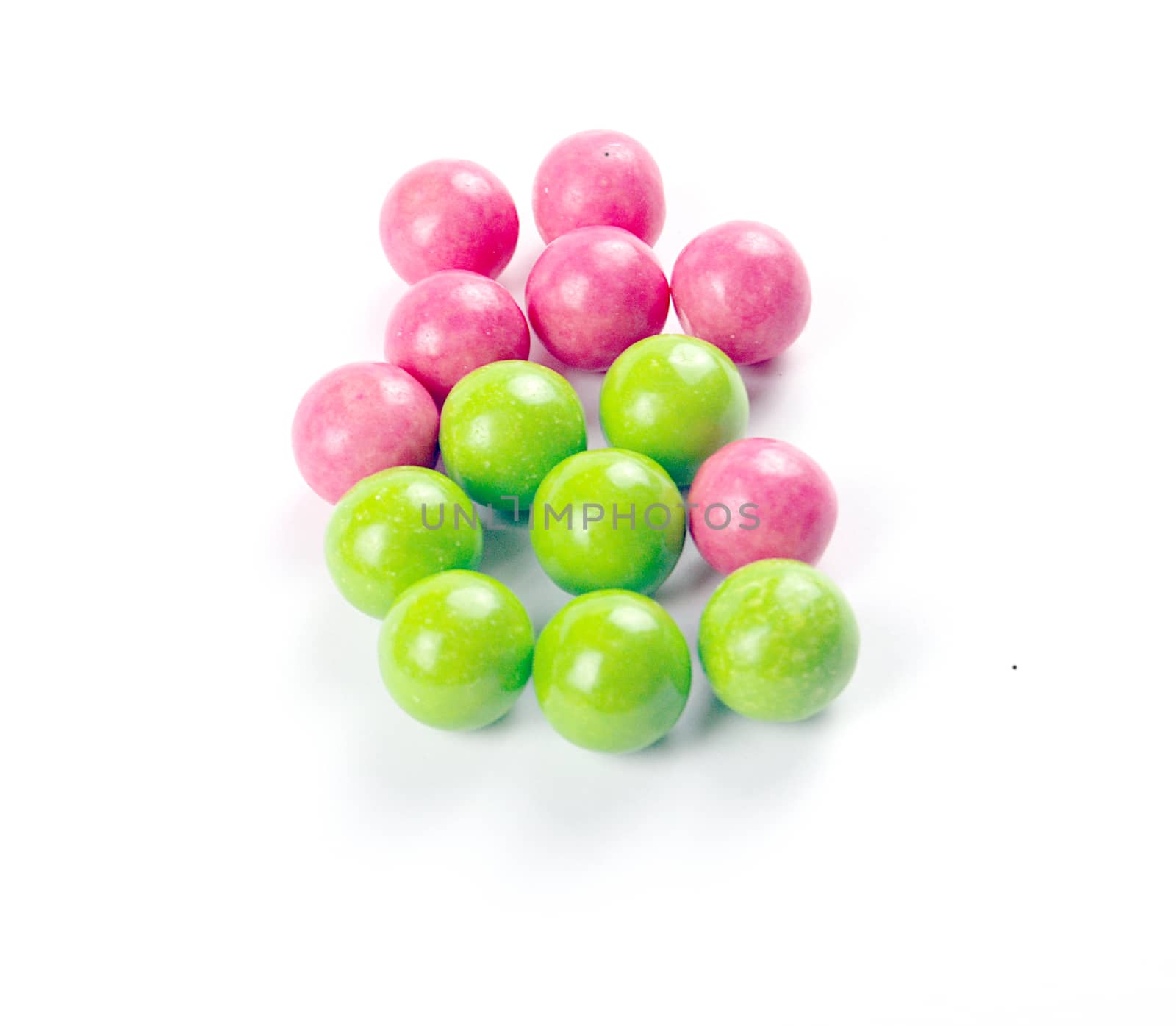 pink and green gumballs on a white background.