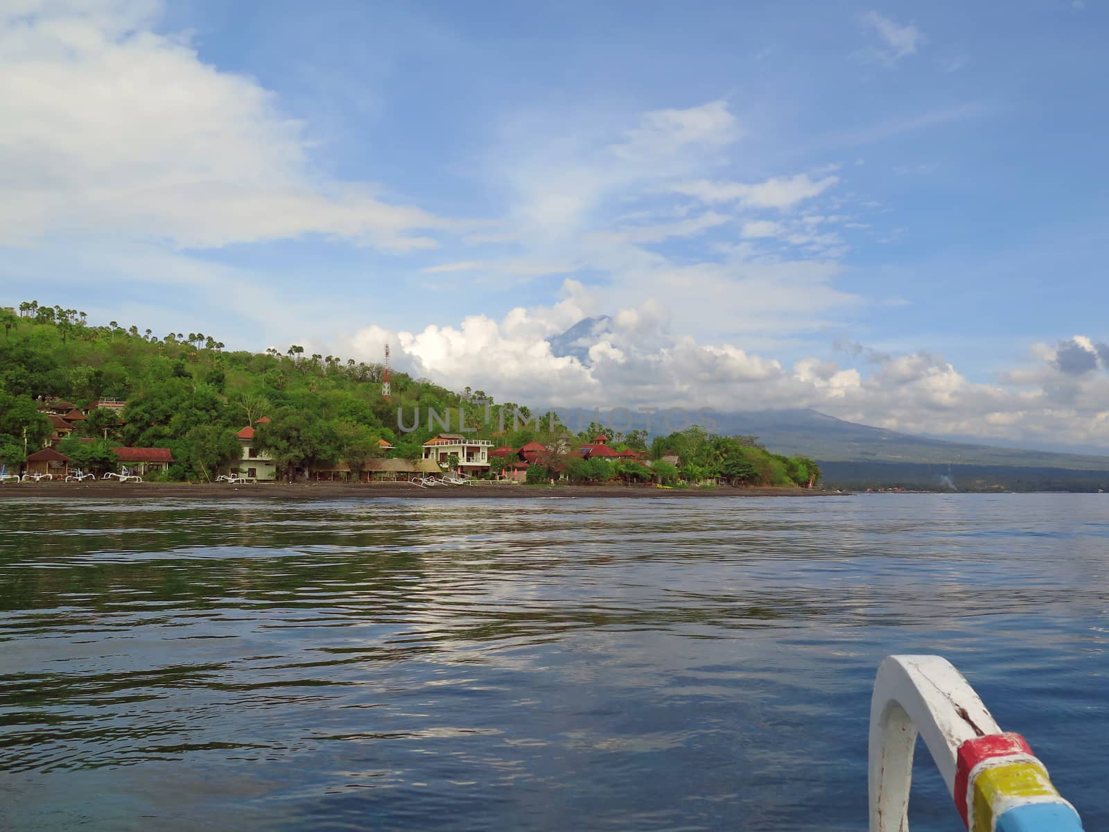 View from boat, lagoon and green coast village. Bali, Indonesia.