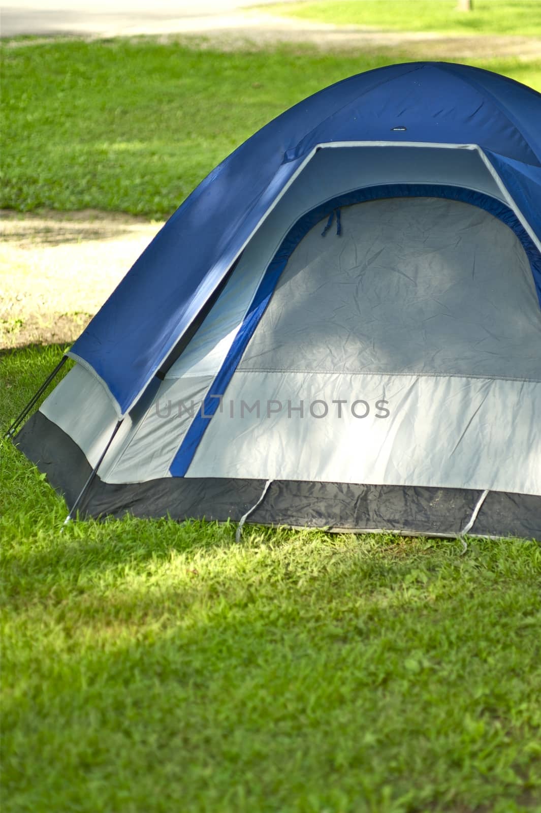 Small Iglo Style Tent on the Campsite. Vertical Outdoor and Lifestyle Photography