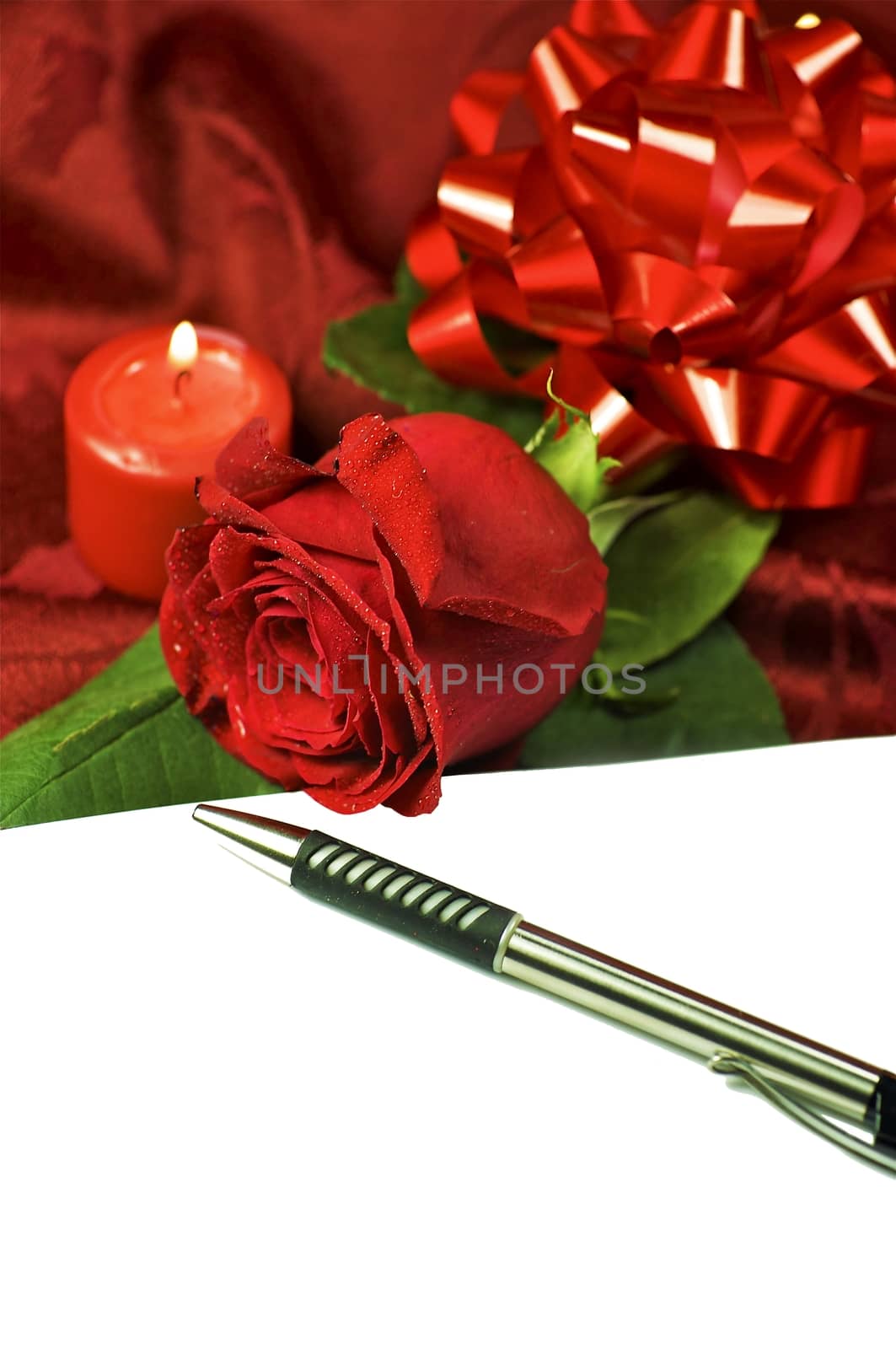 The Love Letter. White Paper, Pen, Red Rose, Red Glossy Bow and Red burning Candle. Valentine\'s Day Theme with Copy Space
