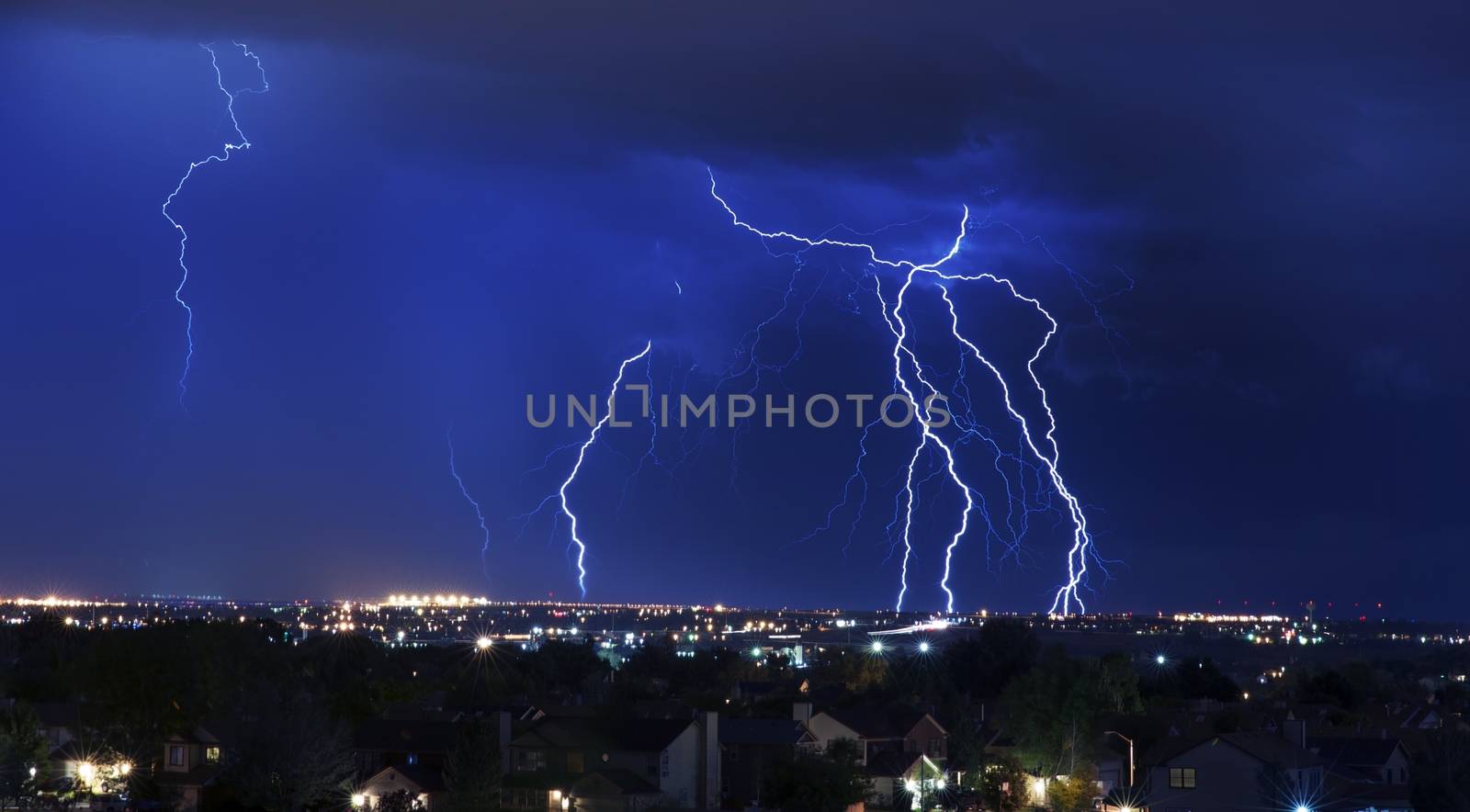 Lightning Storm Over South-West Colorado Springs, Colorado, USA. Overnight Heavy Thunderstorm - City, Storm Cloudscape and Few Lightnings. Powerful Nature Photo.