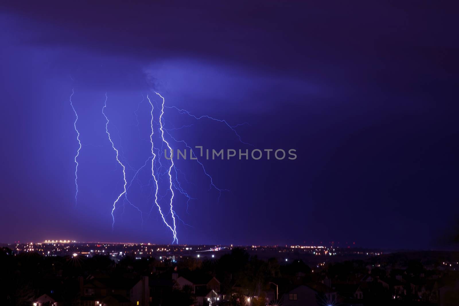 Overnight Lightning Storm. Storm Over City. Few Lightning Strikes. Stormy Overnight Weather in Colorado Springs Metro Area. Horizontal Photo.