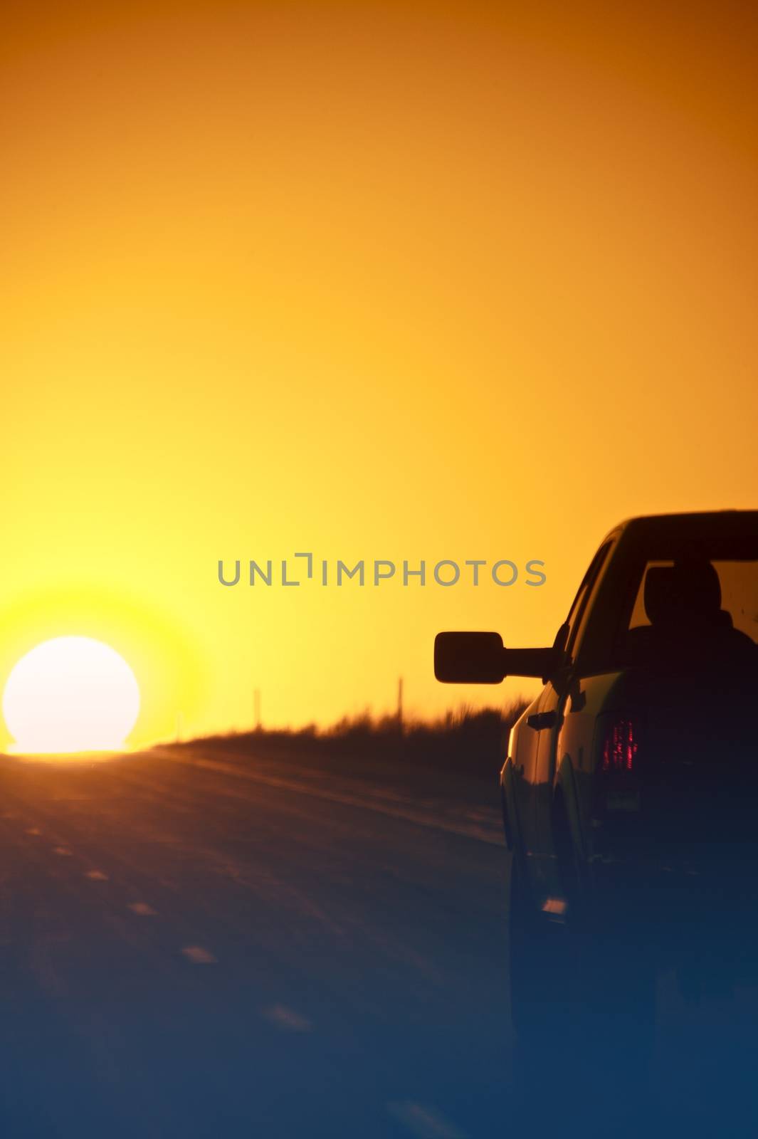 Sunset Outback Highway. Pickup on the Highway - Sunset. Vertical Photo.