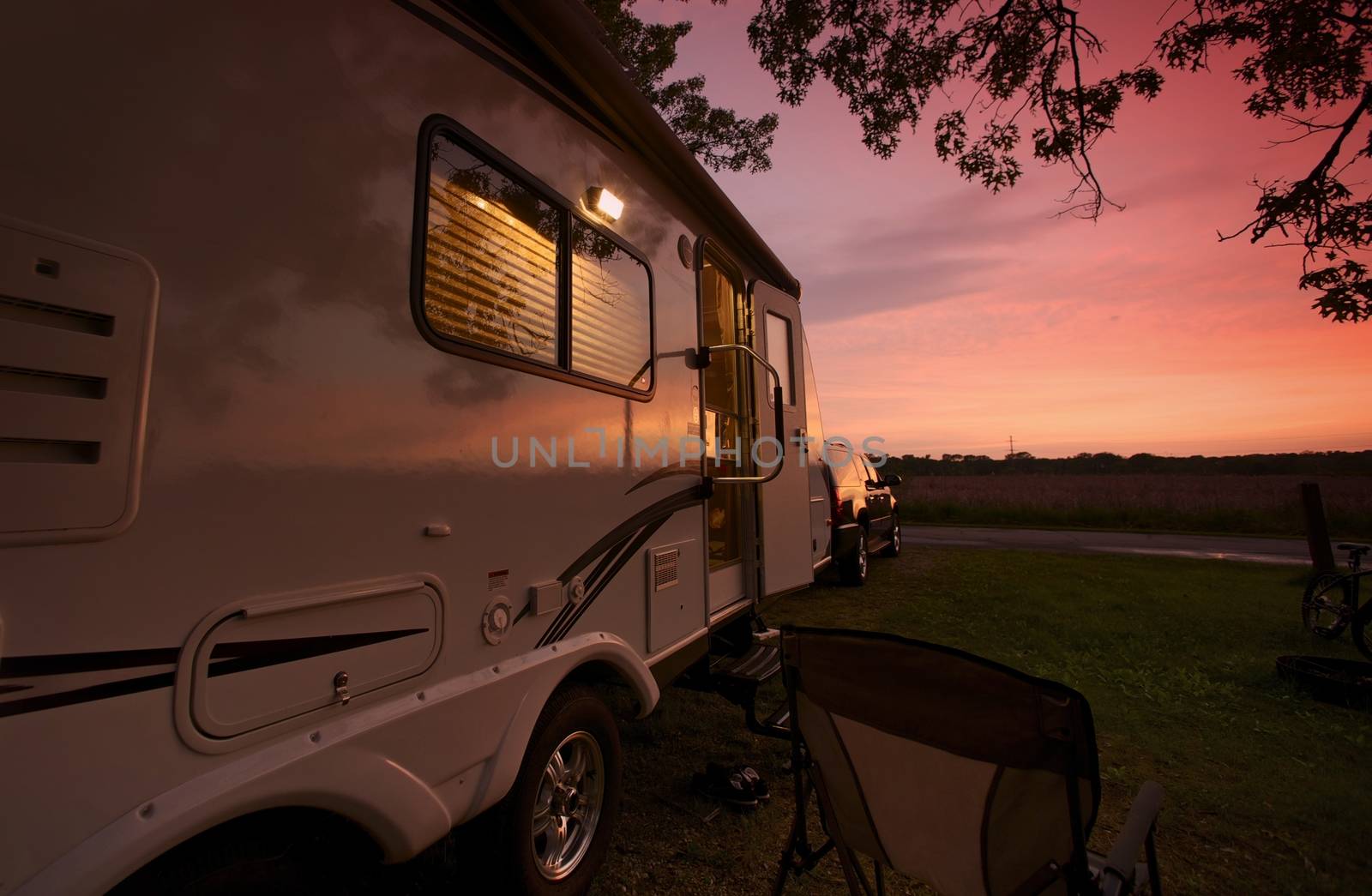 Travel Trailer in Sunset. Camping in Illinois, USA. Recreational Vehicle. RV Theme. Zion, IL - Illinois Beach State Park, USA.