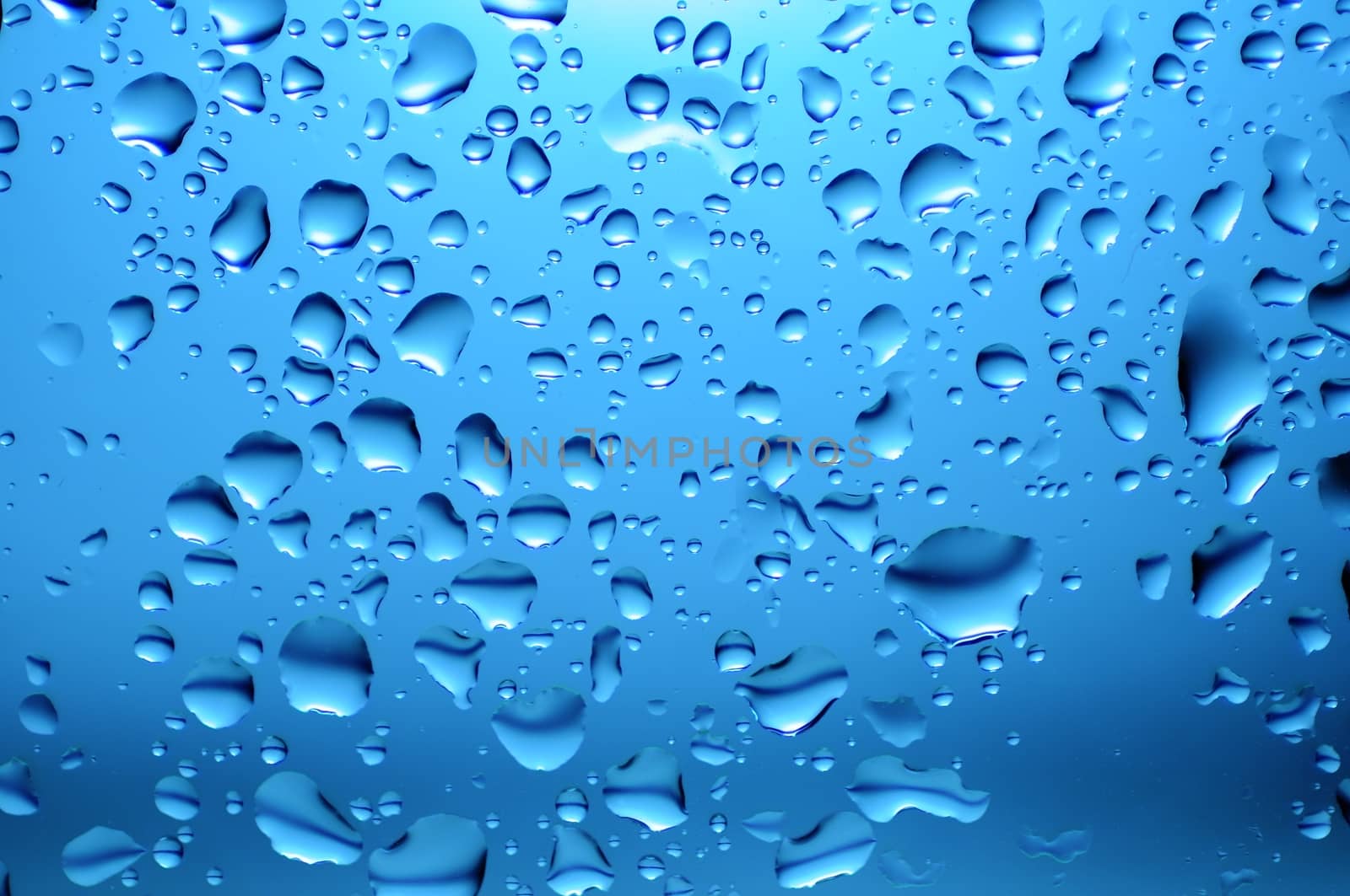 Glass in the Rain. Blue Water Drops