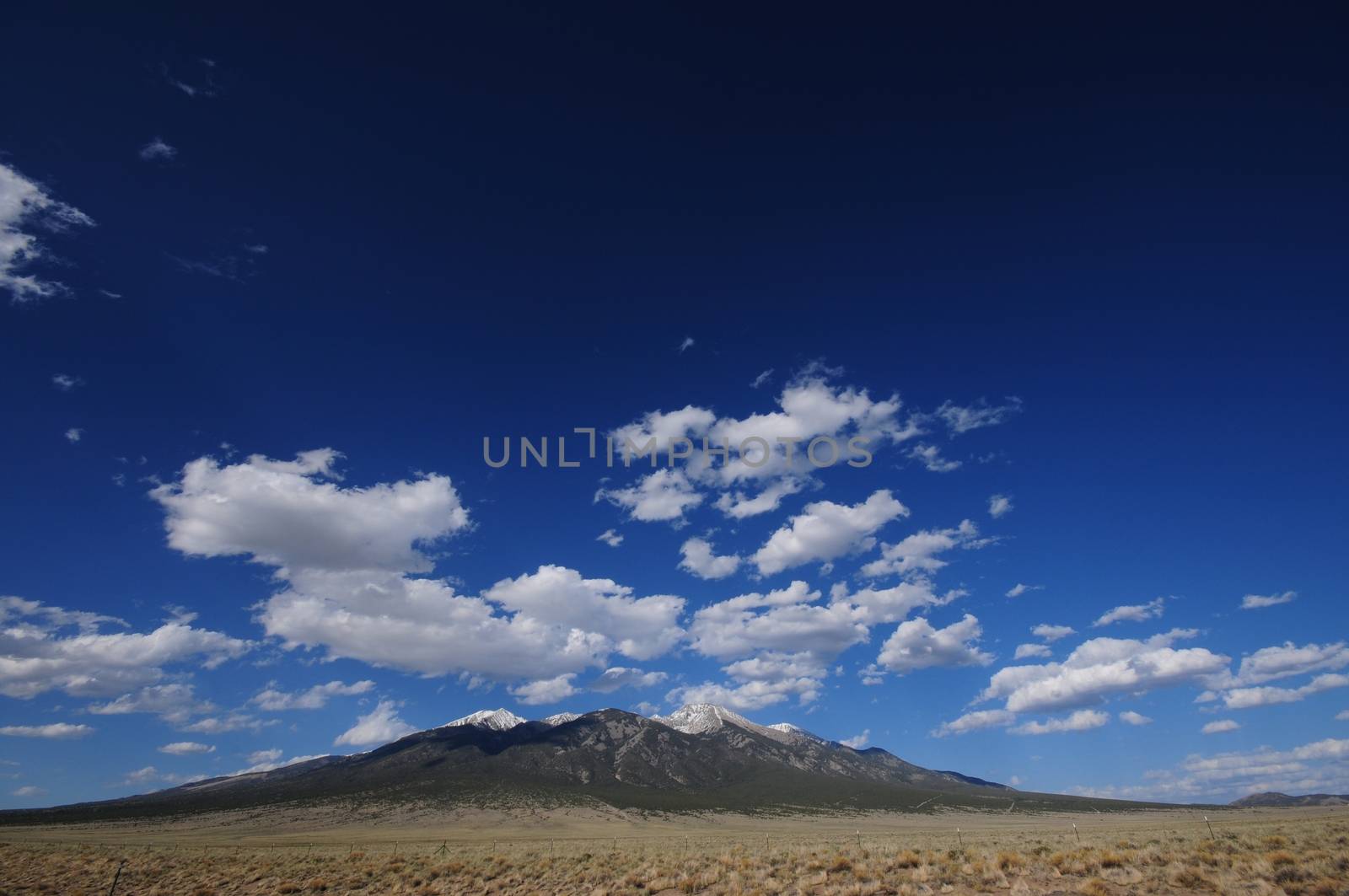 Lonely Mountain - Colorado Rocky Mountains. Dark Blue Sky with Some Small Clouds.