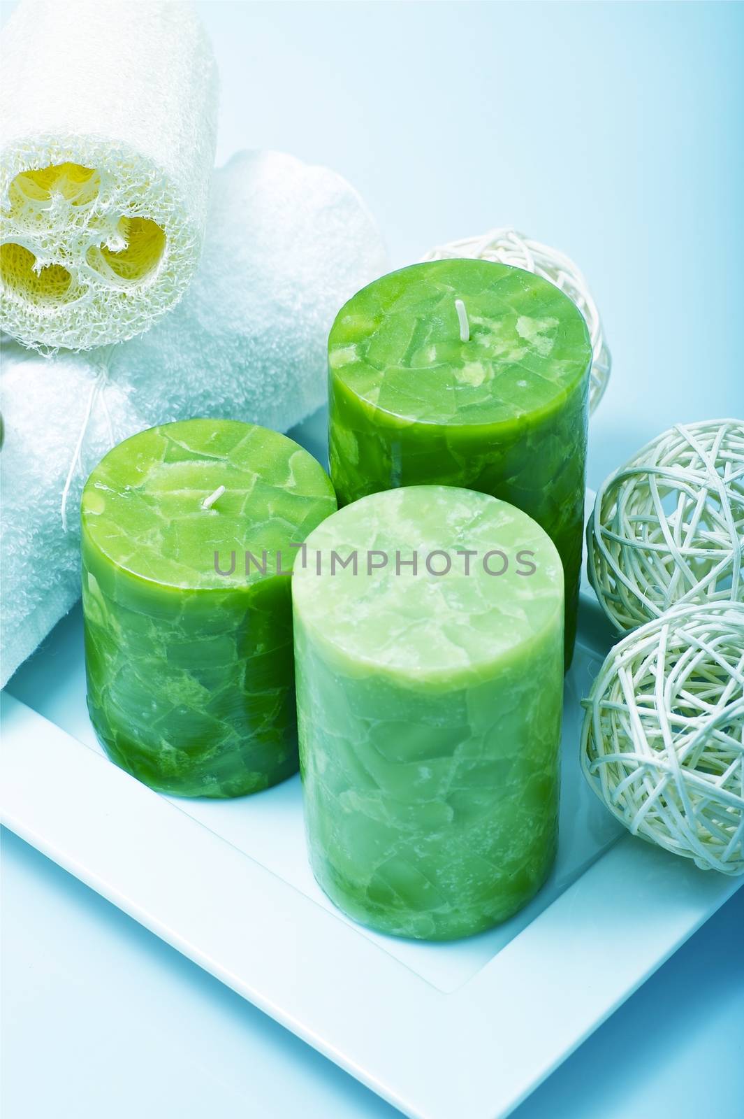 Green Candles on Square Stand and Some Deco Elements. Vertical Photo.