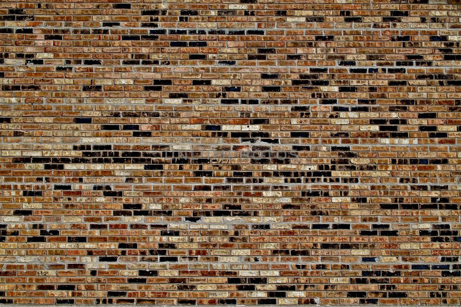Brick Wall Background - Texture. Orange and Black Bricks. Building Exterior