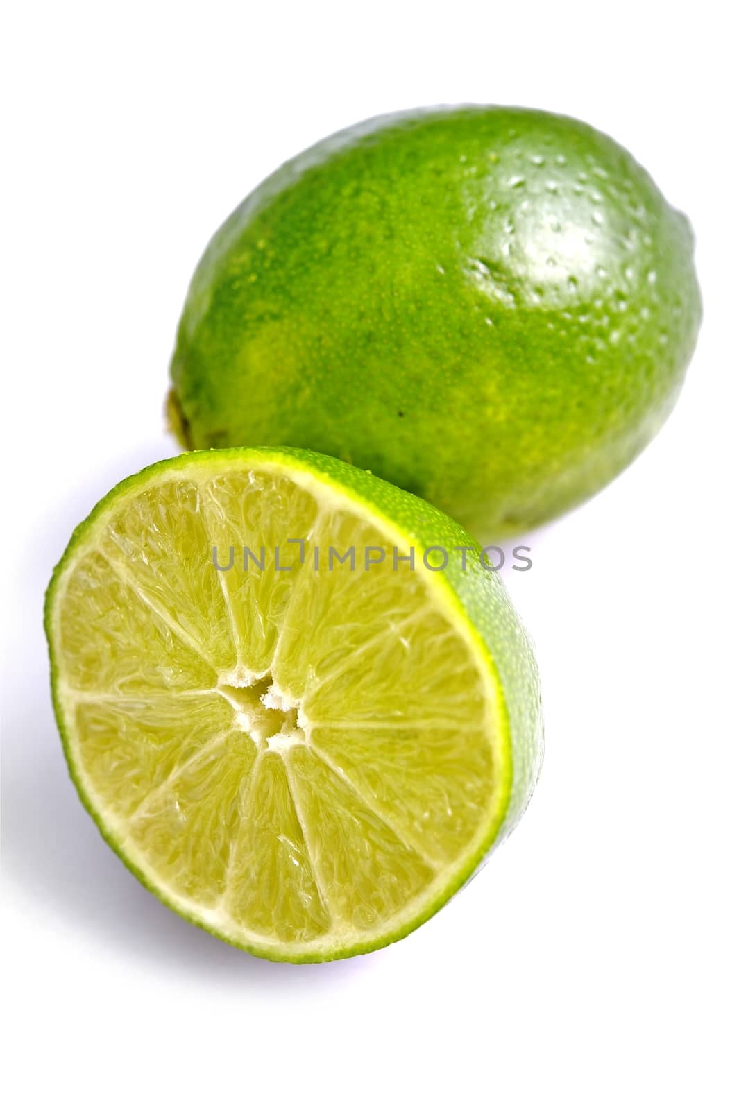 Fresh Limes on White by welcomia