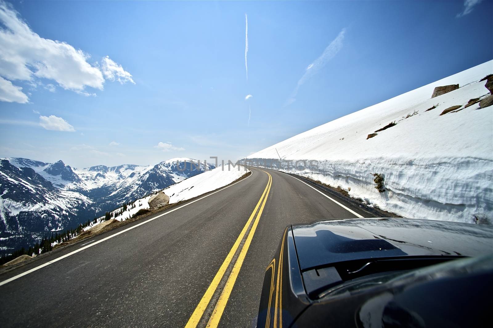 Riding Colorado Mountain Road. Plenty of Sun and Snow. Clean and Dry Road. Mountains Landscape.