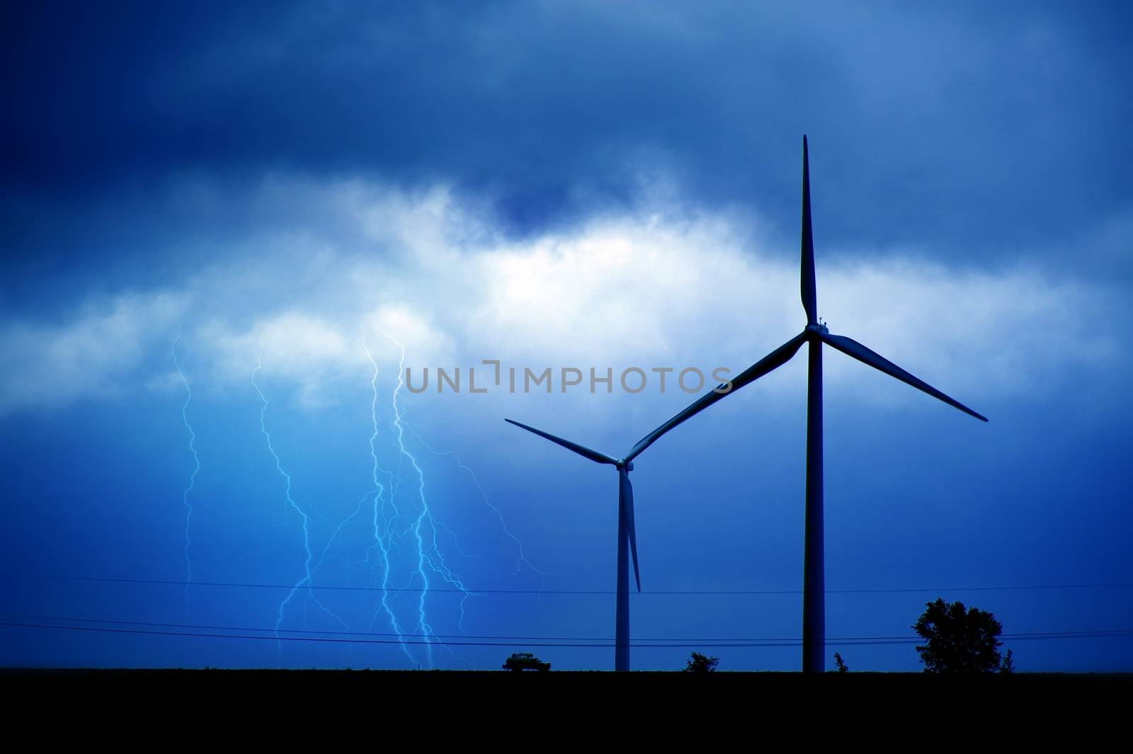 Wind Turbines and Summer Lightning Storm. Technology and Nature Theme. Bluish Colors.