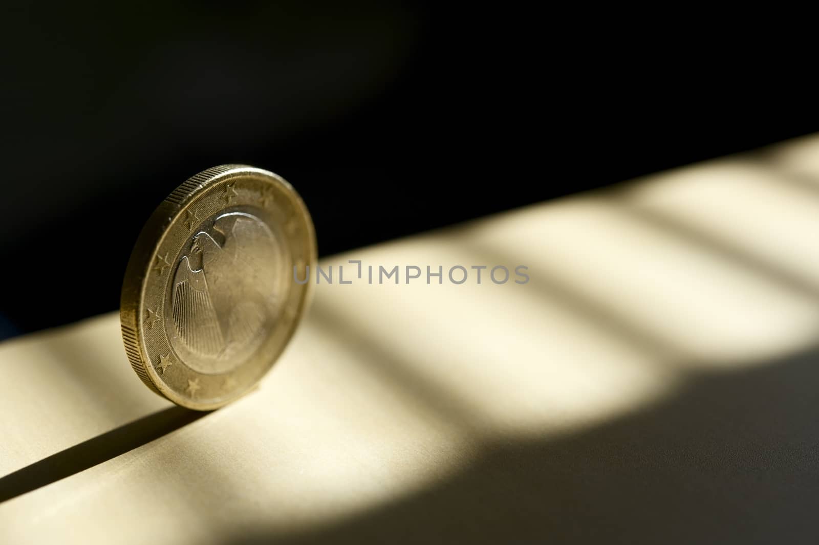 Rolling Euro Coin in the Spot Light. Business Theme Photography.