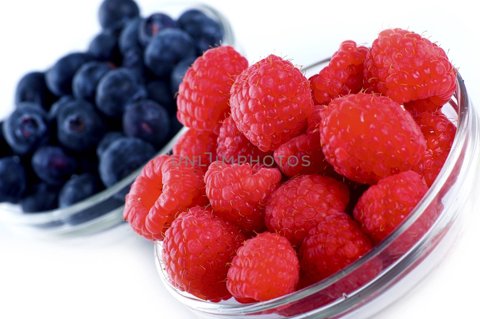 Raspberries and Blueberries Fruits in Glass Bowls. Fresh Raspberry - Fresh Blueberry Studio Photo.