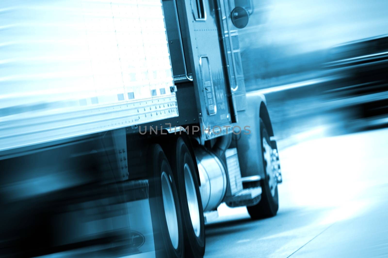 Semi Truck in Motion. Semi Track Speeding on the American Highway. Motion Blurred. Blue Tones. Transportation and Spedition Photo Collection.