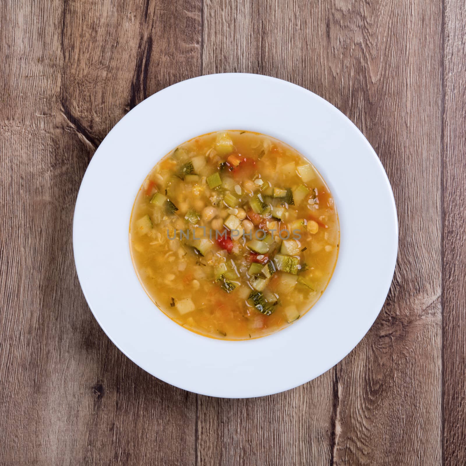 Vegetarian vegetable soup on a wooden table