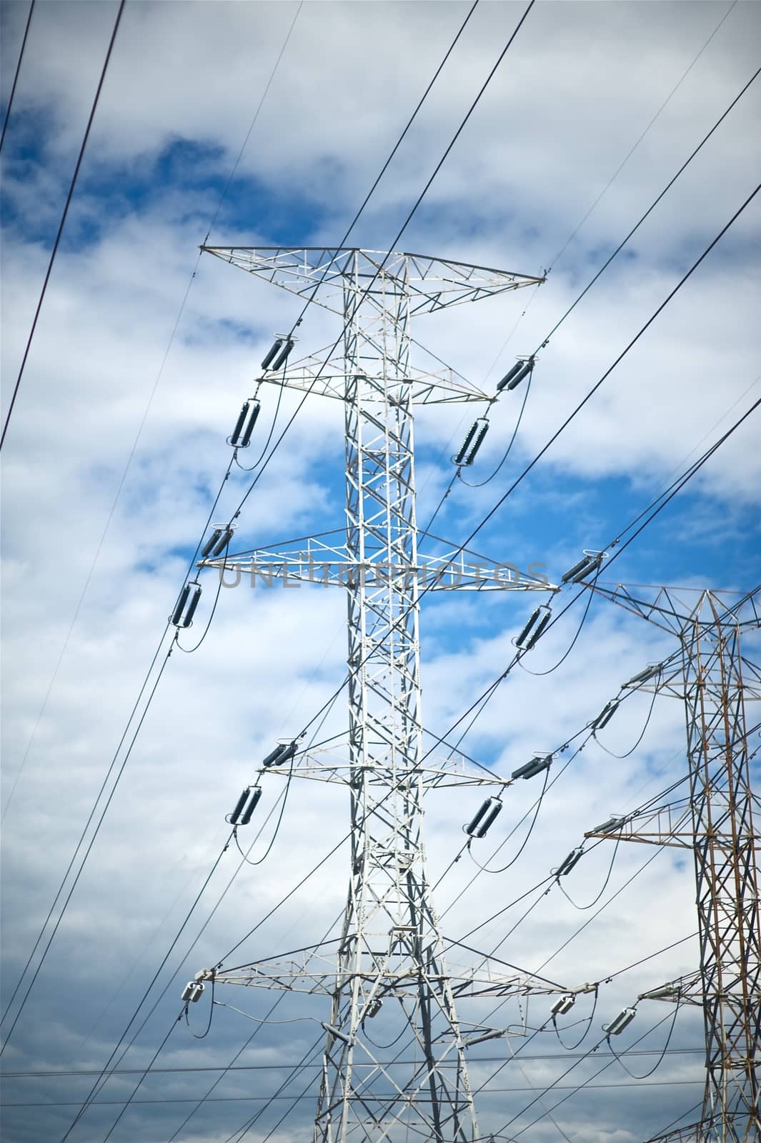 High Voltage Pole on the Blue Sky. High Voltage Electric Systems.