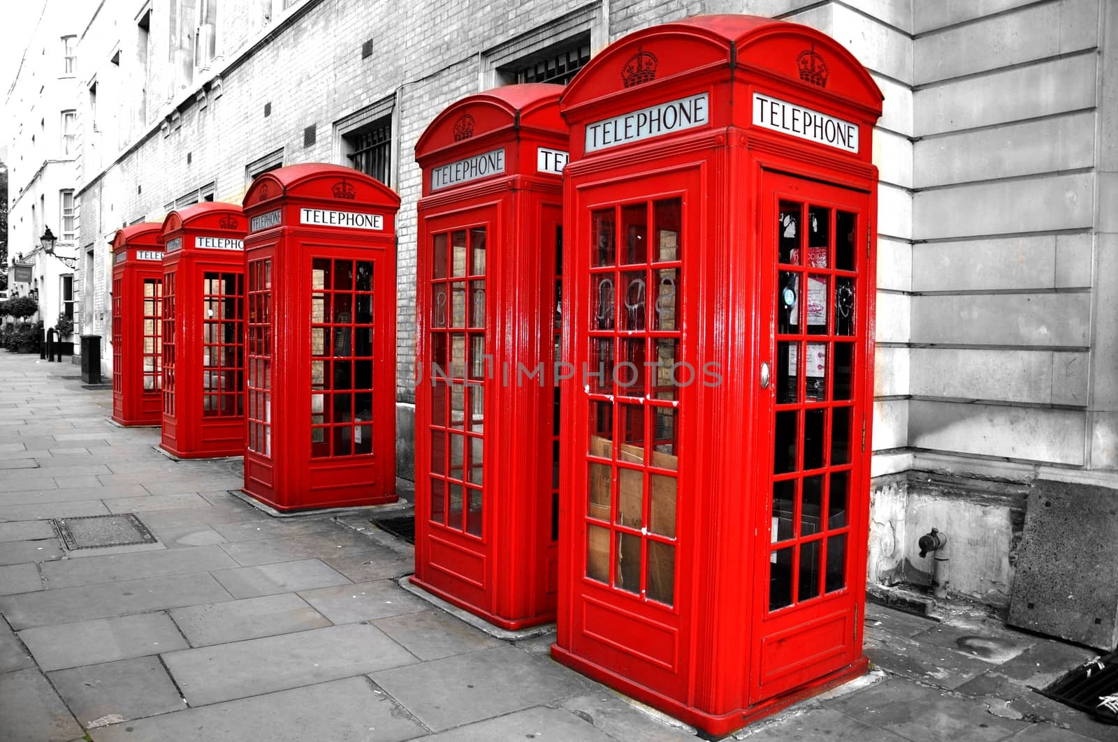 London Red Telephone Boxes on the Street. Black and White Buildings and Street with Red London Telephone Boxes
