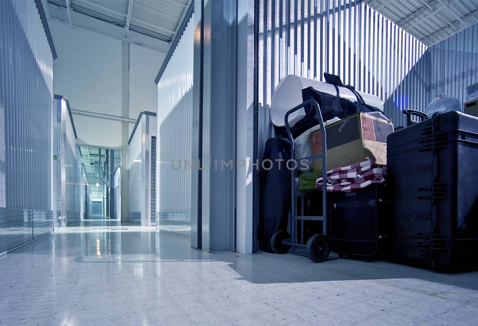 Fully Loaded Storage Unit and Storage Facility - Warehouse Hallway. Climate Controlled Storage Building.