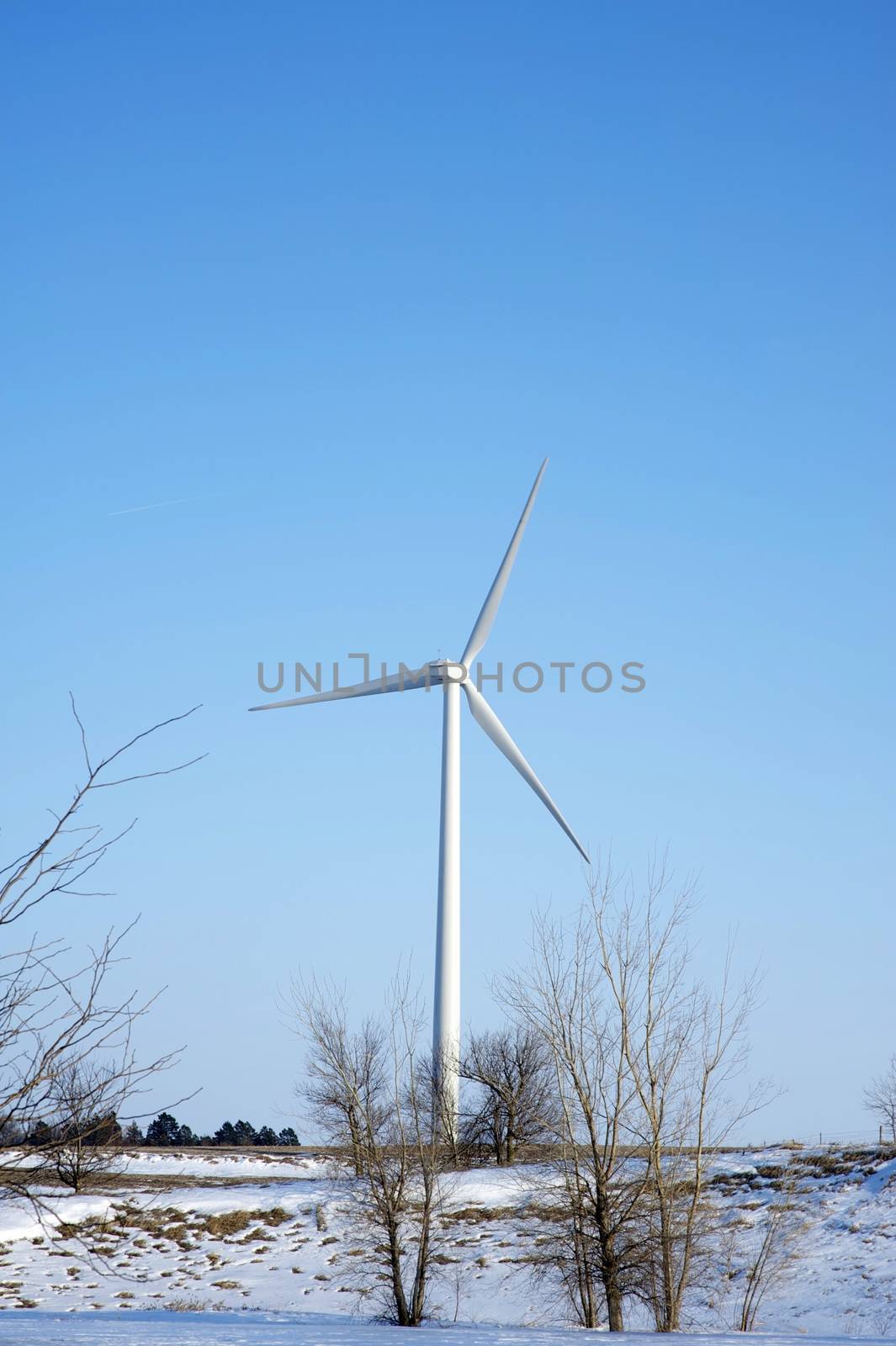 Wind Energy Turbine - Wind Turbine in Winter Time. Nebraska, U.S.A. Vertical Photography