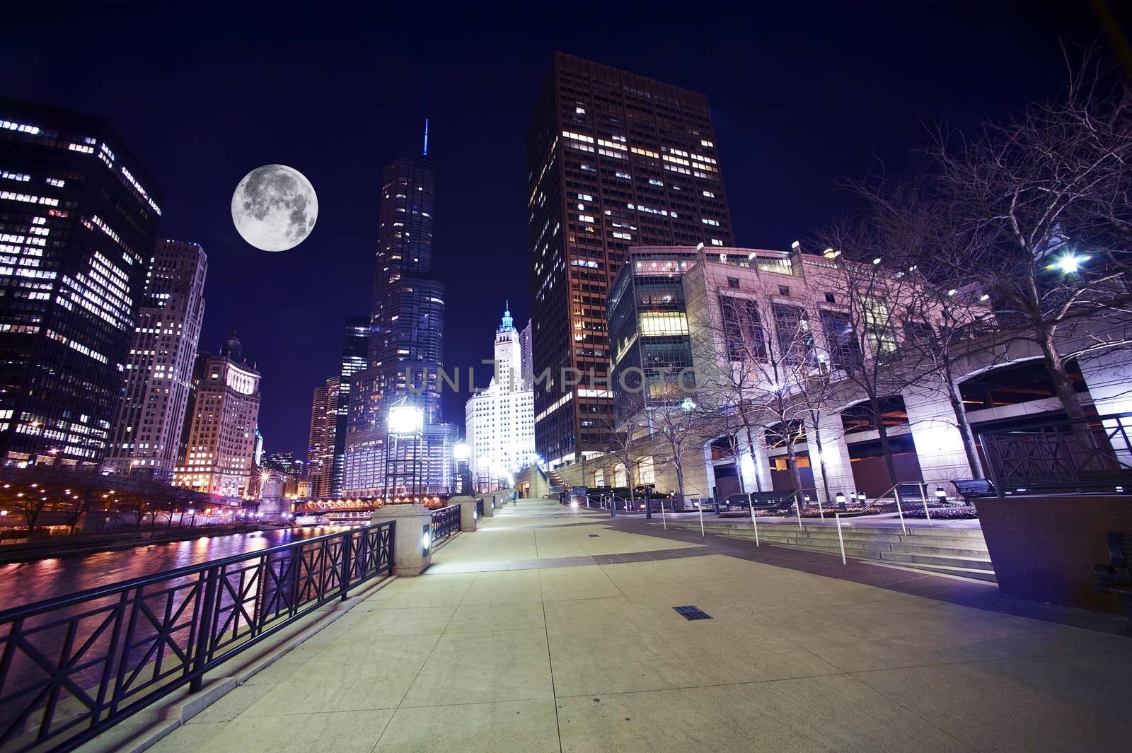 Chicago Famous Riverwalk - Chicago Riverwalk at Night. Beautiful Colorful Wide Angle Photography. Large Moon on the Sky. Chicago, Illinois, USA.
