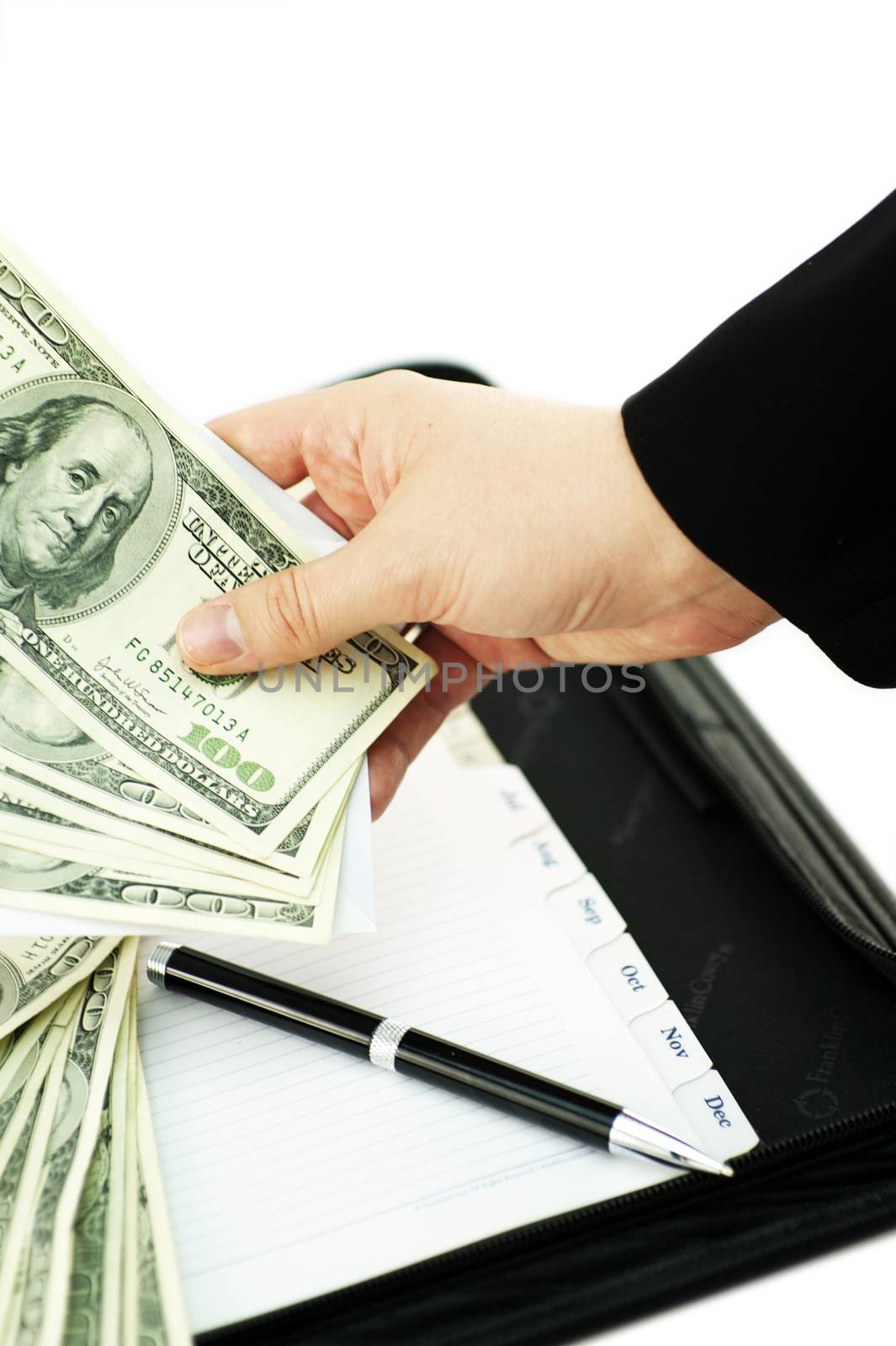 Accounting Theme. Female Hand, Few Hundred of US Dollars, Black Notepad / Organizer and Black Pen. White Solid Background. Isolated Photo.