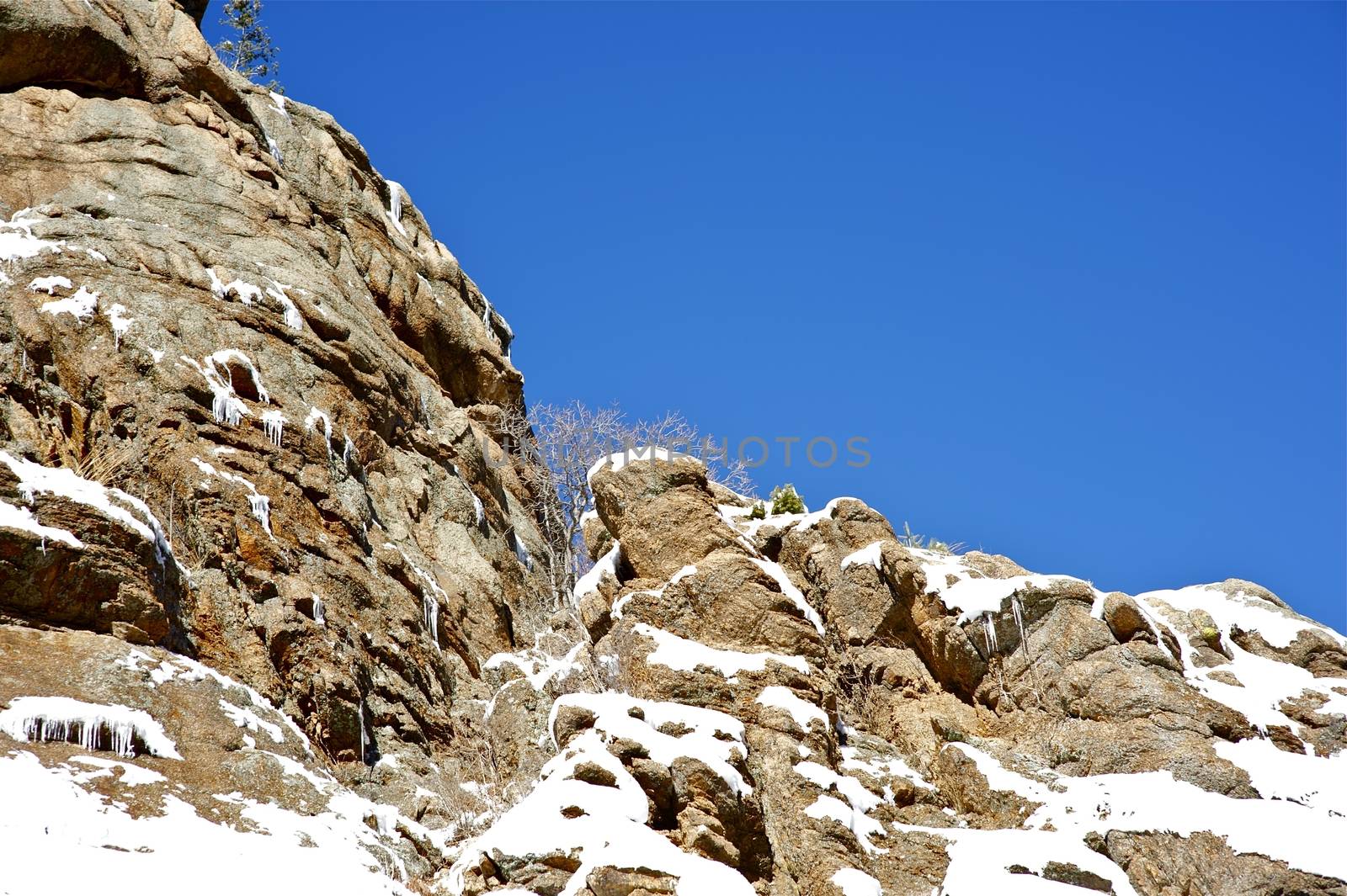 Winter in Rocky Mountains, Colorado USA. Rocks in Snow. Clear Blue Sky