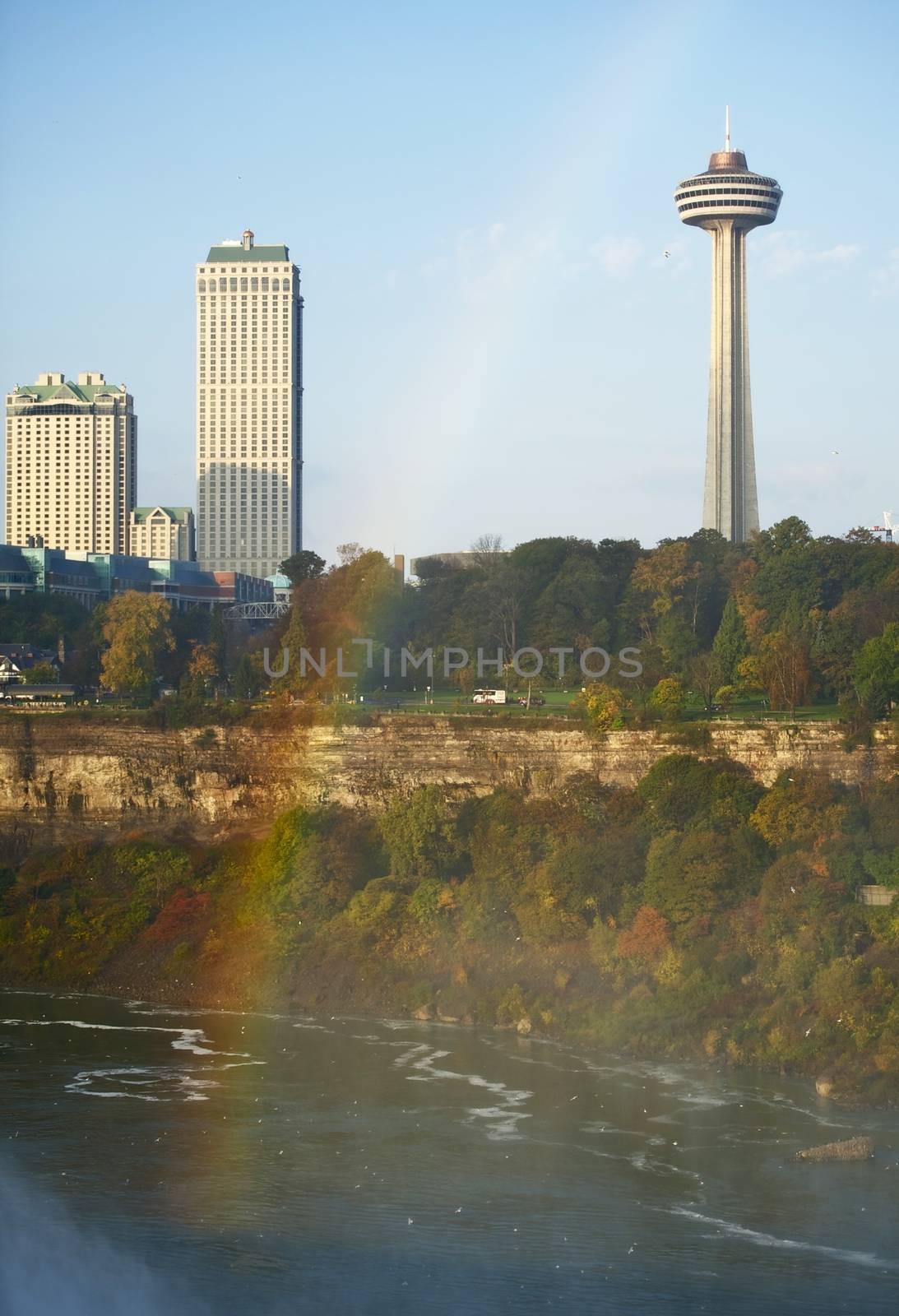 Niagara Falls, Ontario, Canada. Niagara River and NIagara Falls Downtown. Rainbow Above the River. Vertical Photography.