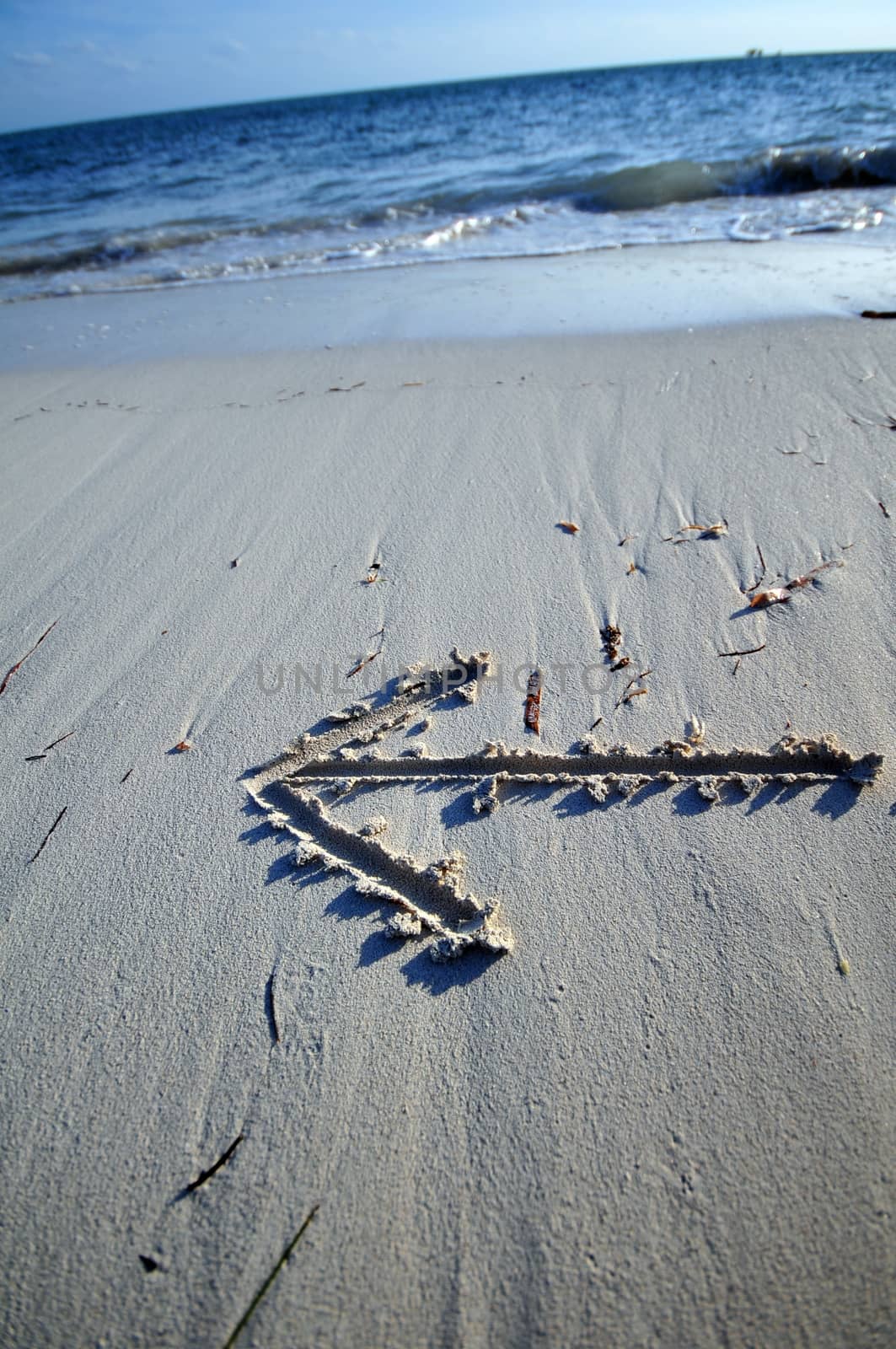 Destination - Arrow on the Beach Sand. Atlantic Ocean - Go Left.