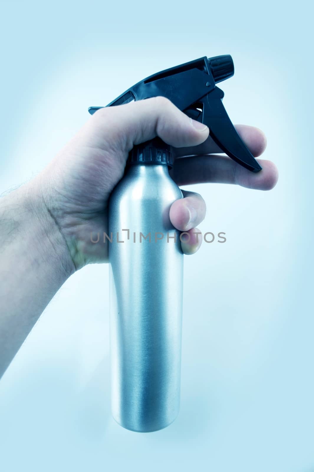 Water Sprayer. Men Hand. Light Blue Background.