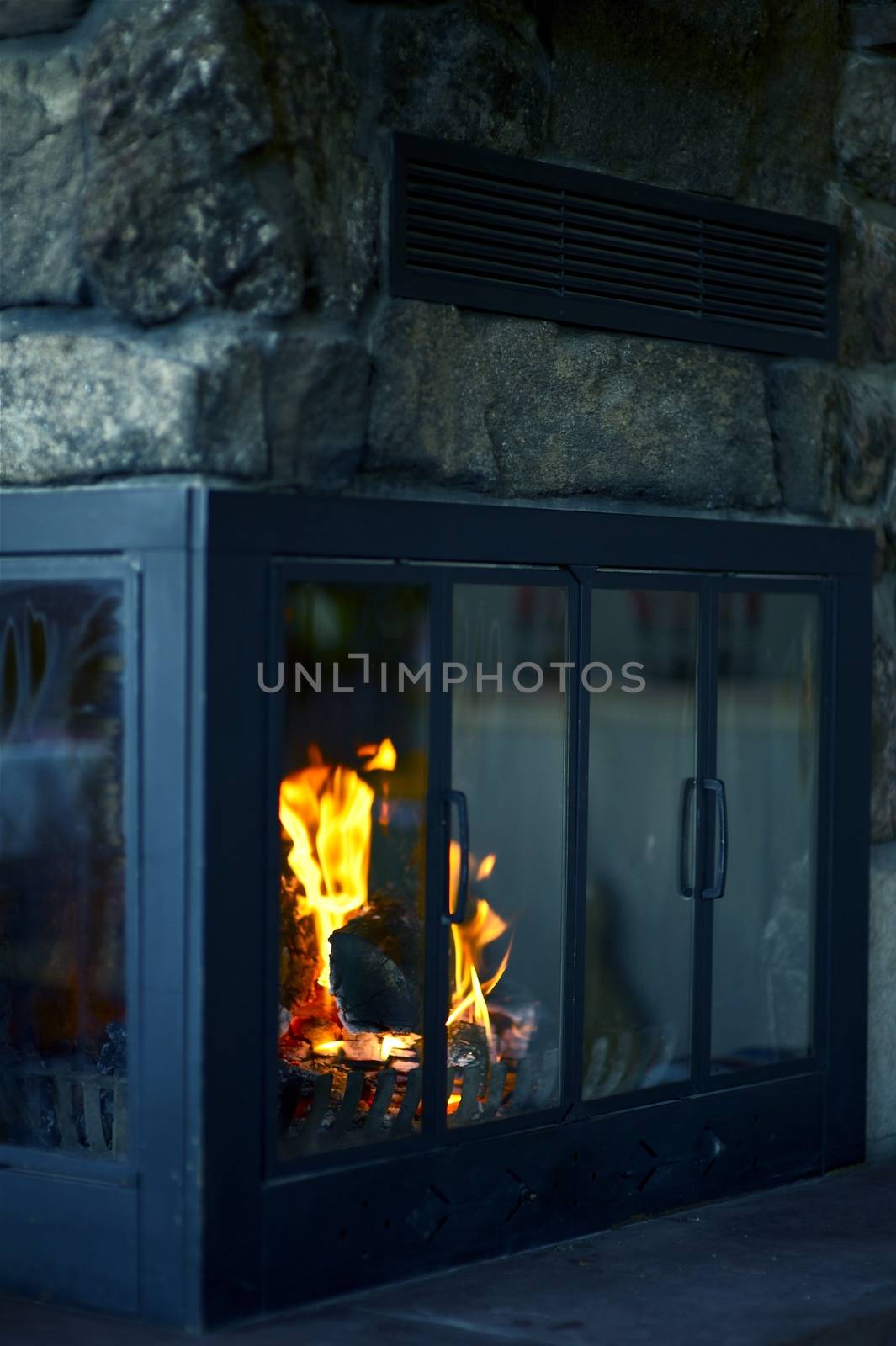 Cozy Fireplace in Mountain Log Home. Vertical Photography.