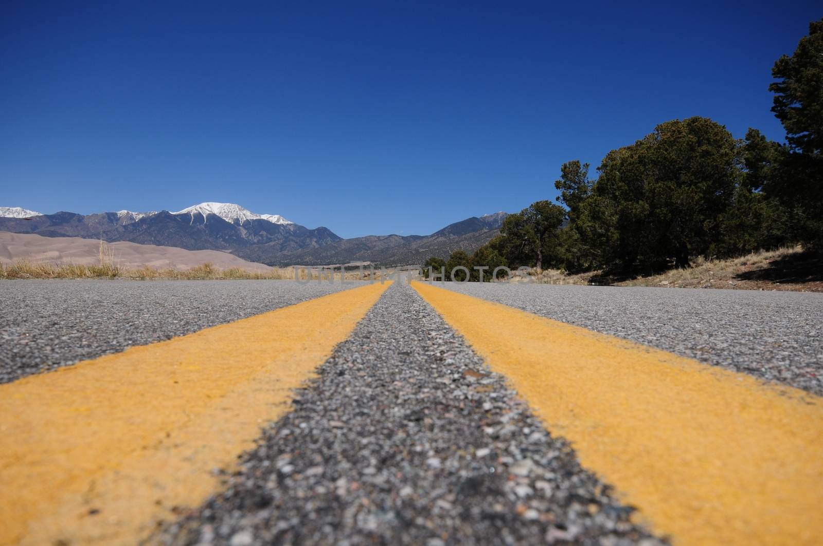 Road to the Dunes. Colorado Highway. Road to the Great Sand Dunes National Park in the Central of the Colorado State. Yellow Road Lines