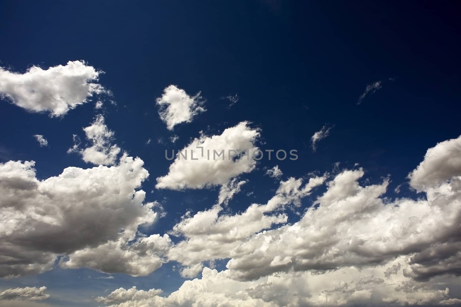 Dark Blue Sky. Dark Blue Summer Cloudscape Background. Horizontal Photo. Weather Backgrounds Collection.