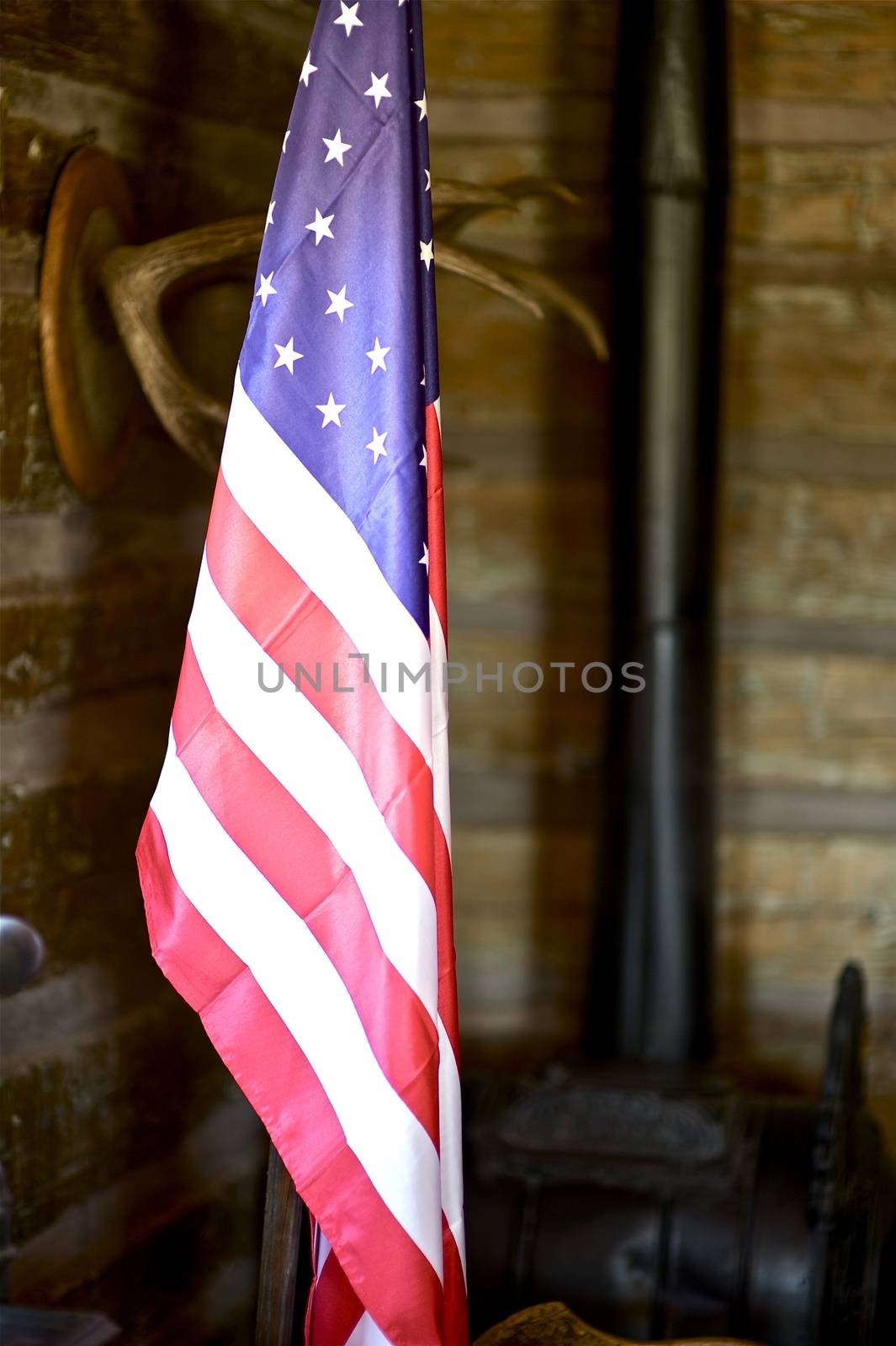 North American Flag. United States of America Flag on Stand in the Vintage Far West Wood Room. Vertical Photo