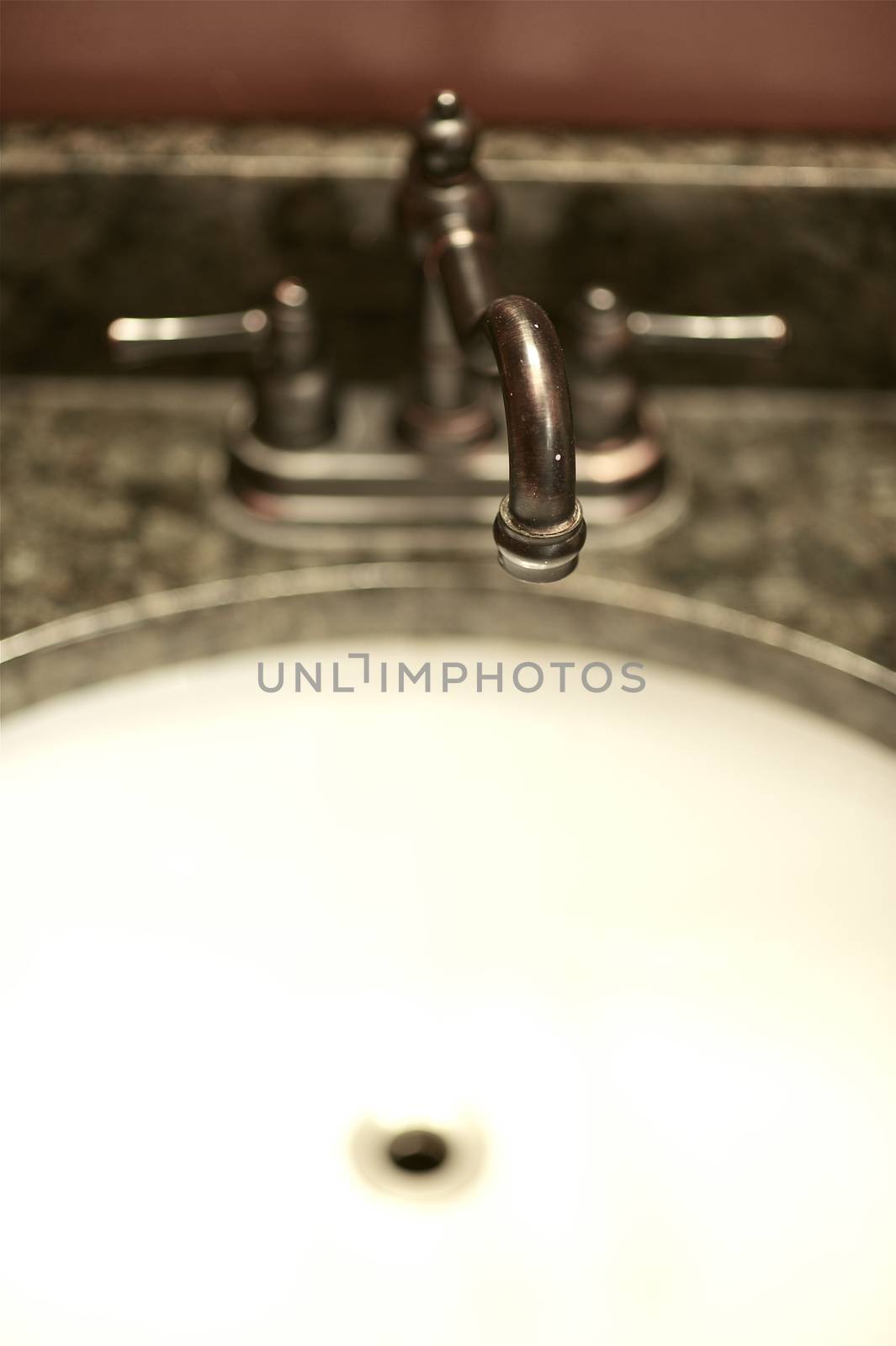Brown Metal Faucet and White Basin - Bathroom Interior.