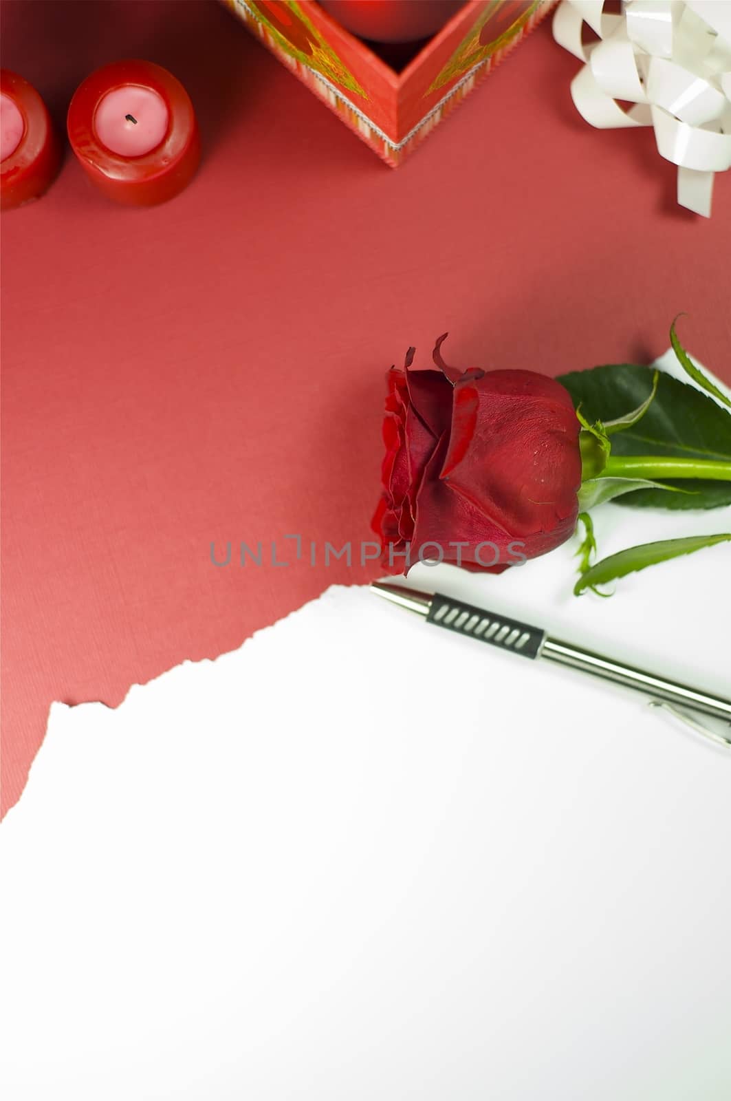 Red Rose Message. Red Rose Flower, White Paper and Red Candles. Great Copy Space for Special Occasions.