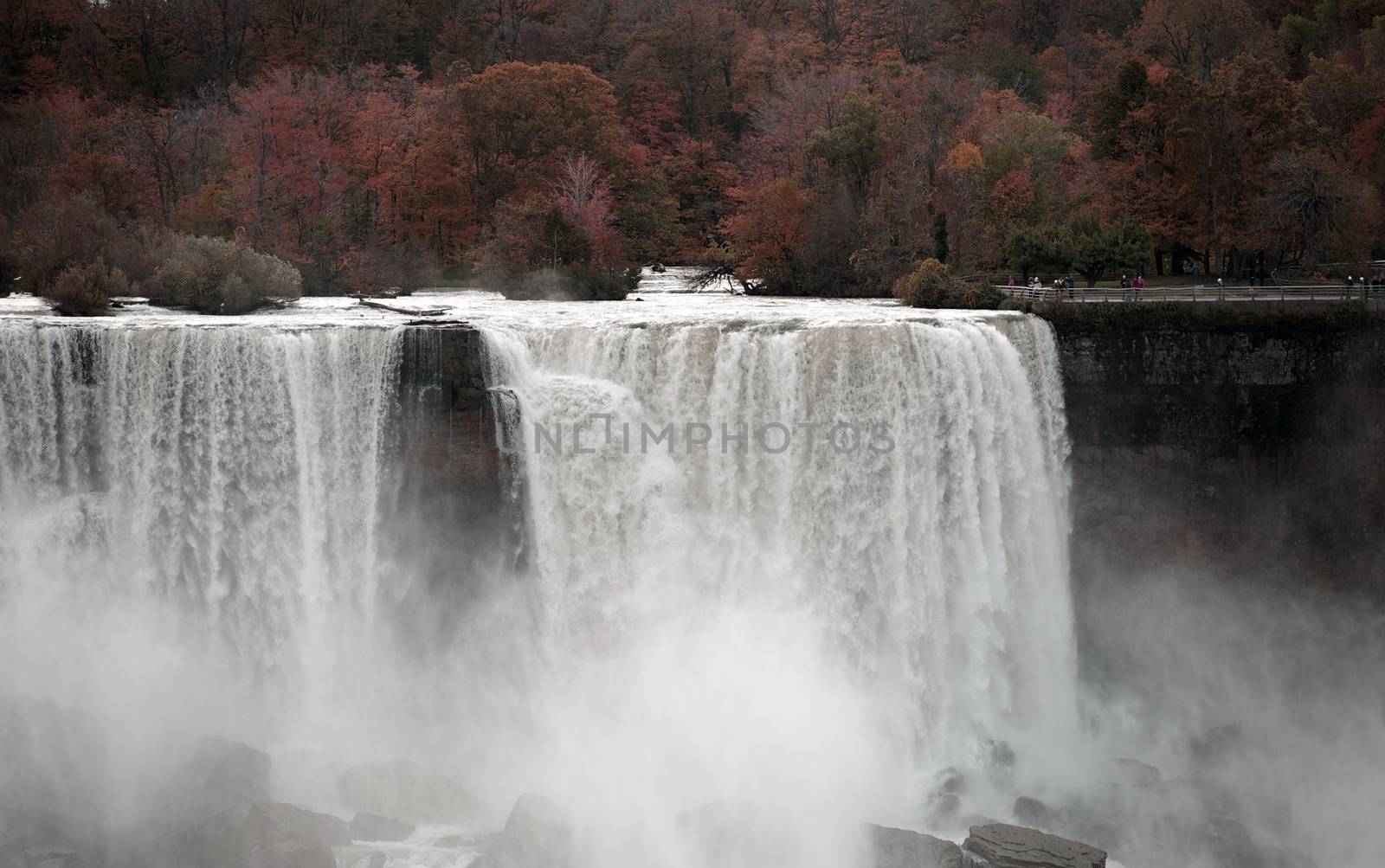 International Falls - Niagara Falls. Autumn/Fall Photography. Taken From Canadian Side. American Side of Niagara Falls with Turists on the View Point. Horizontal Photo.