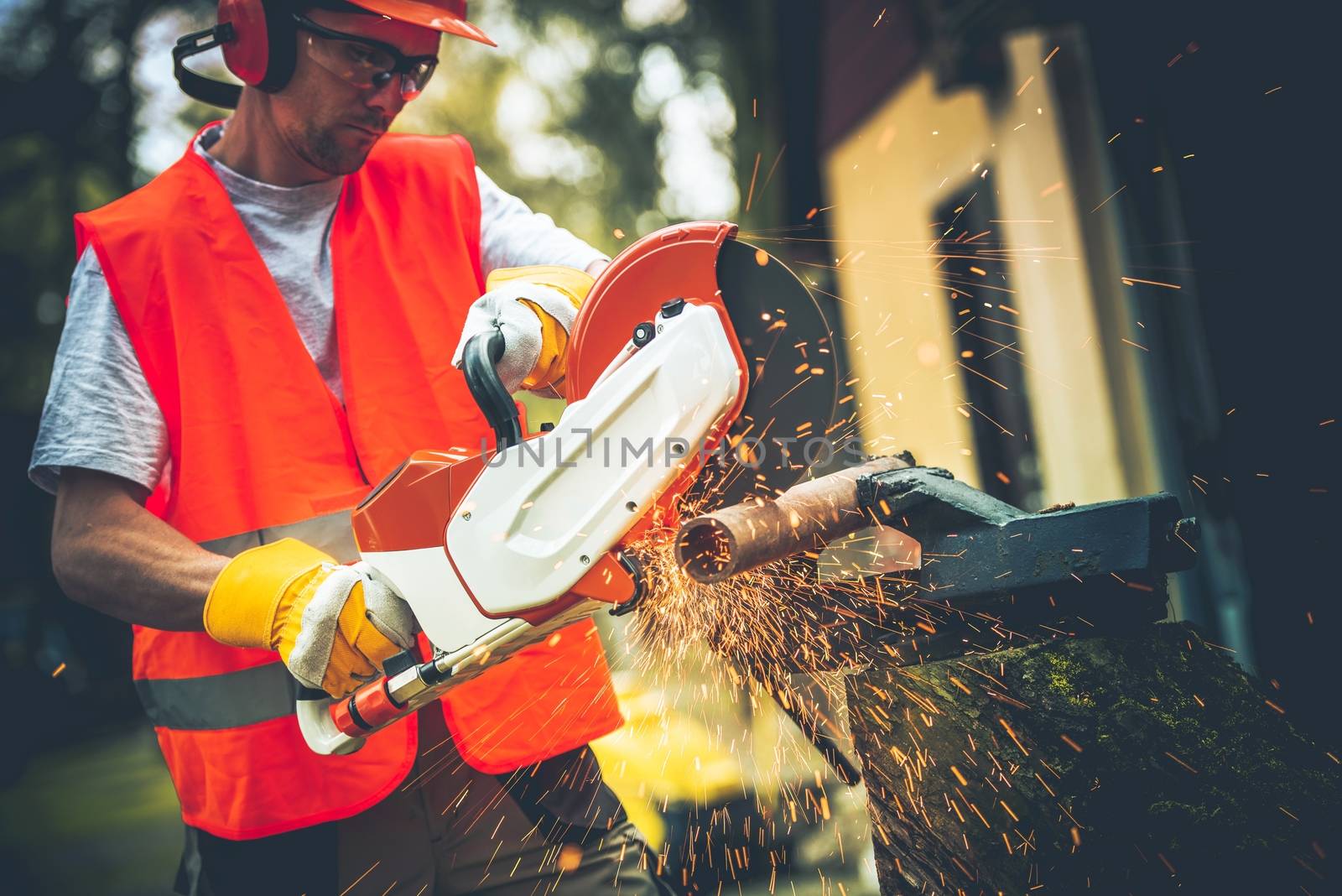 Men Using Mobile Electric Metal Cutter. Pipe Cut. Construction Theme.