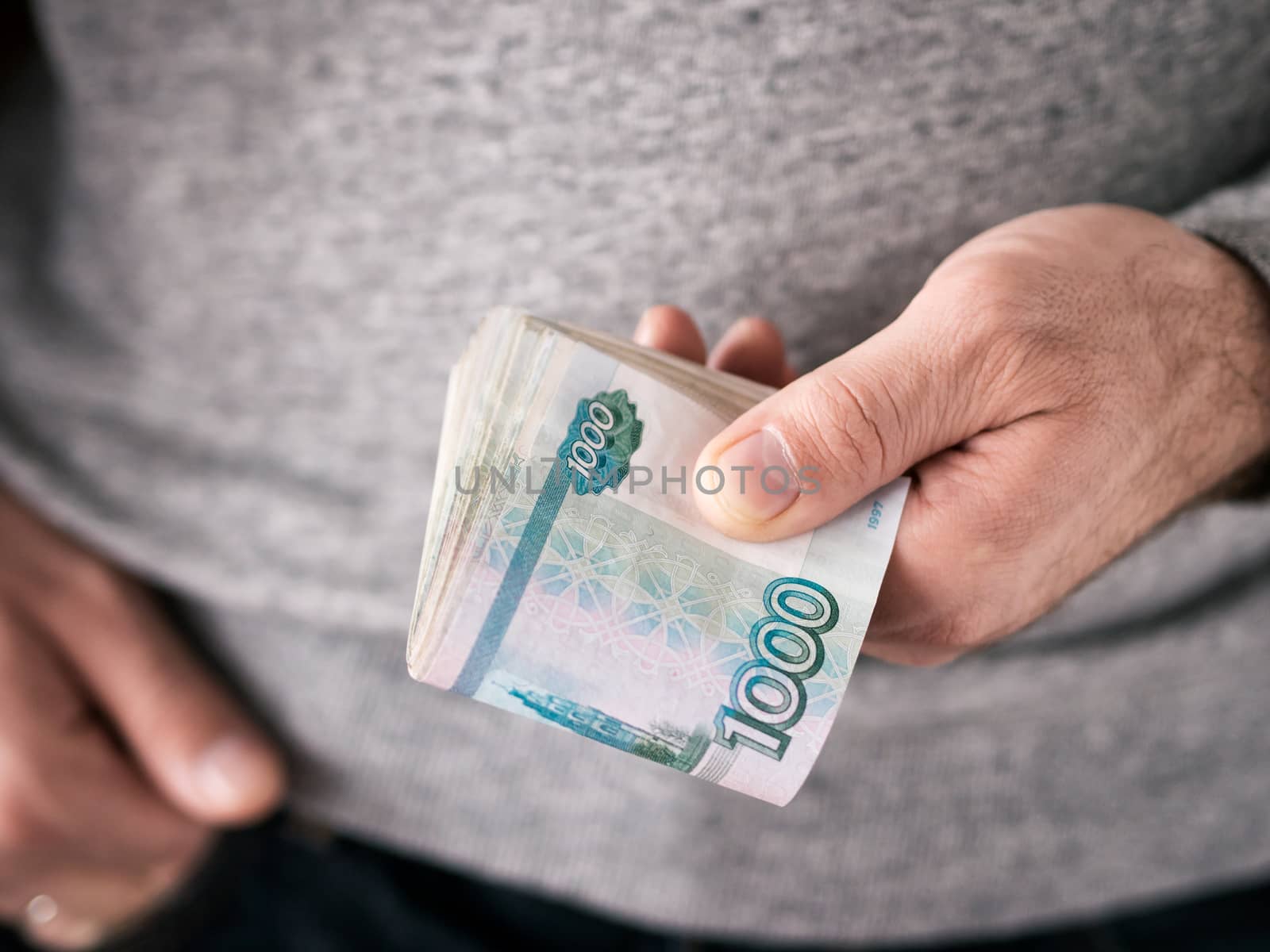 Hands hold russian rubles. Selective focus. Shallow DOF