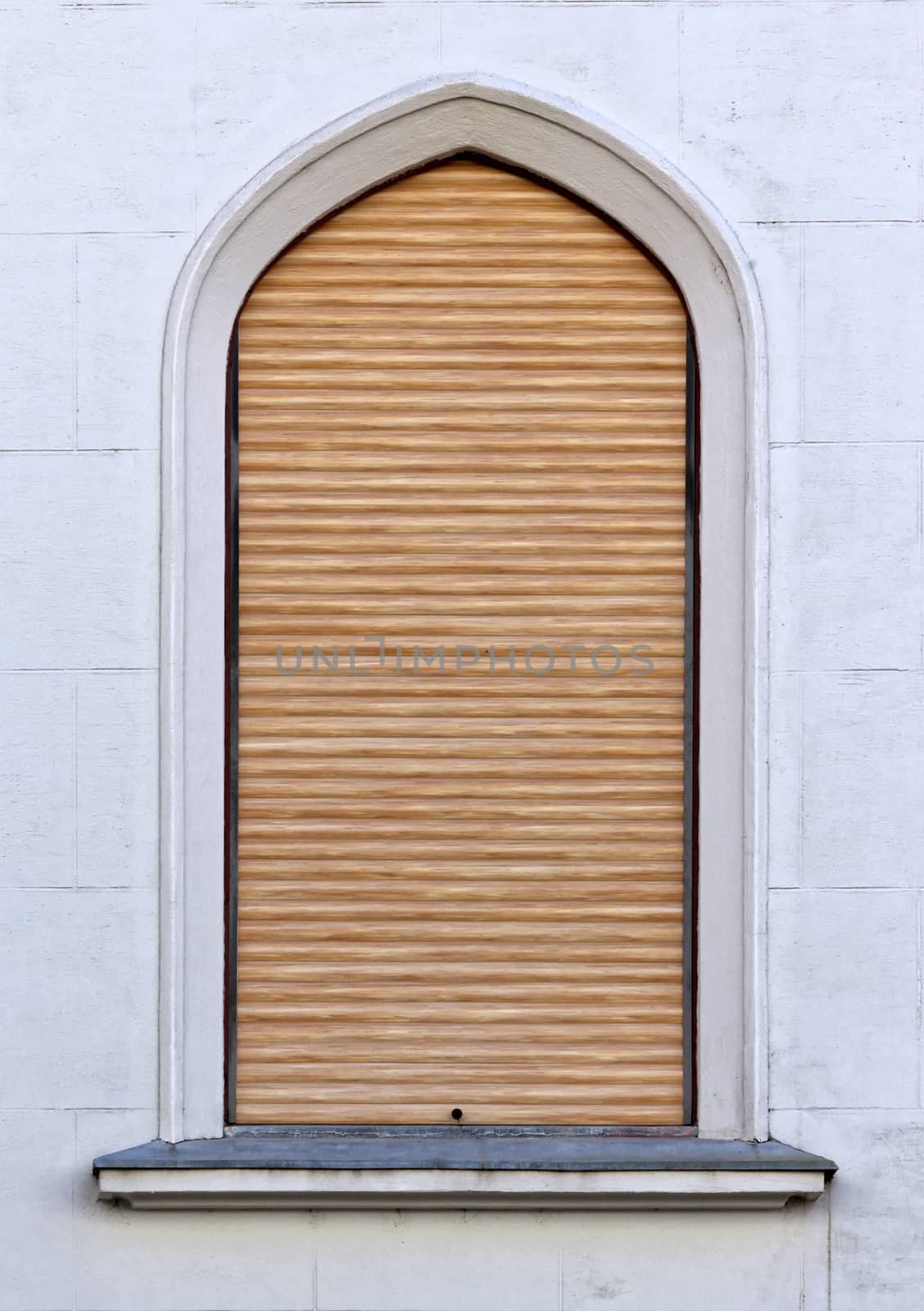 Vaulted closed blinds brown castle window.