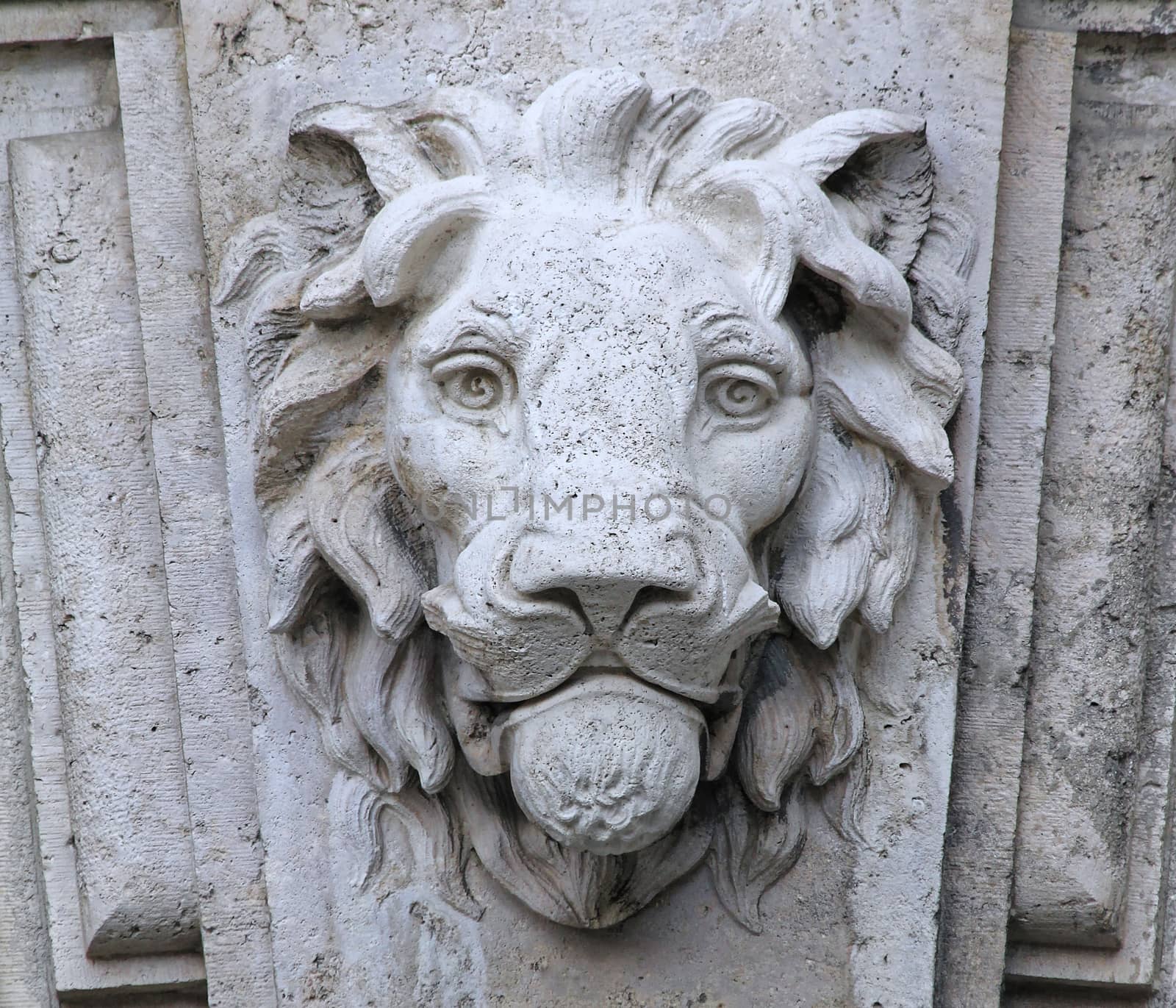 Castle building is decorated with carved stone face.