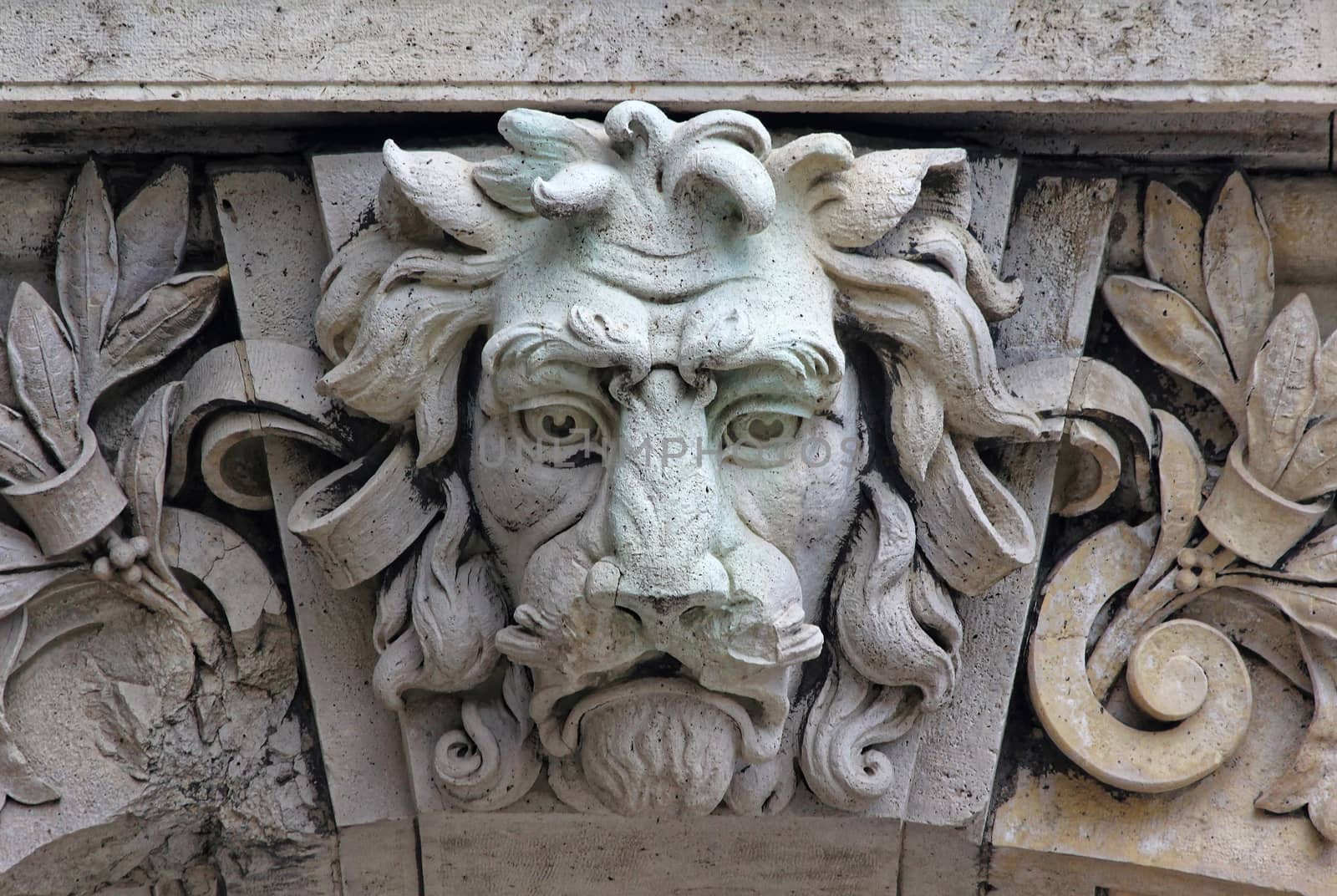 Castle building is decorated with carved stone face.