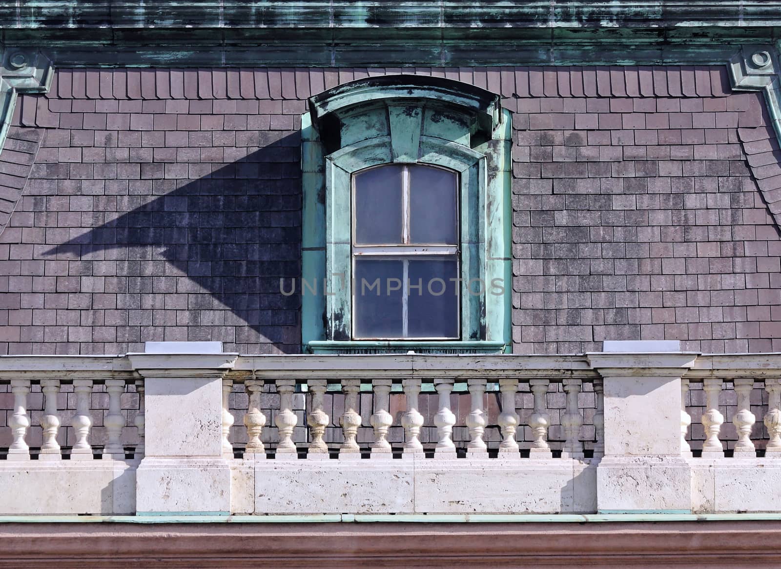 weathered old ornate dormer windows and roof tiles.