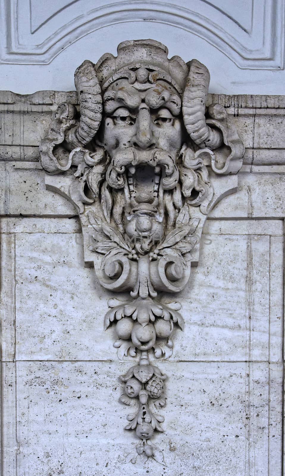 Castle building is decorated with carved stone face.