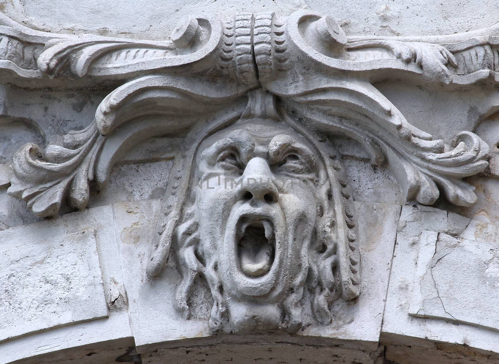 Castle building is decorated with carved stone face.