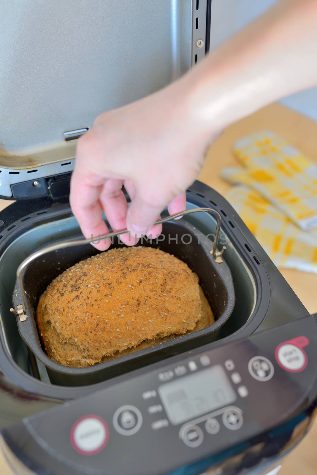 Bread machine with pan and fresh bread at home