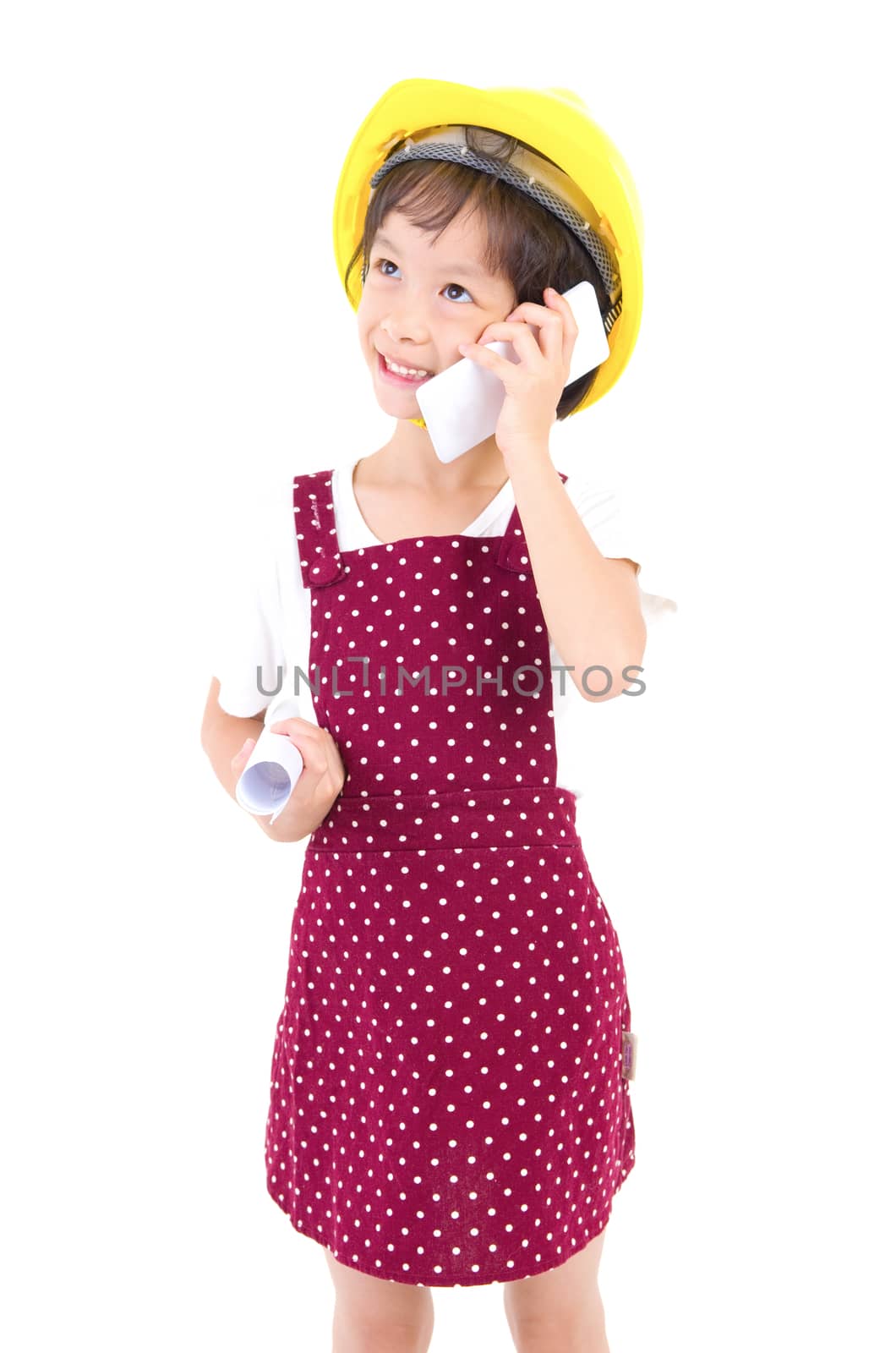 Little Engineer wearing the construction helmet,talking with smartphone and  olding a contruction drawing, isolated over white background.
