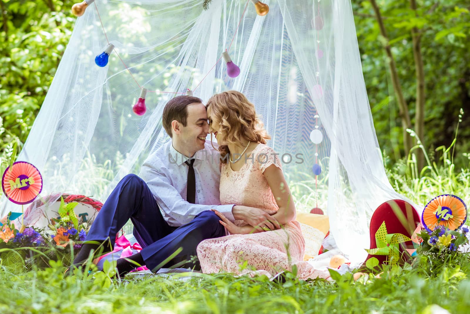 Smiling man and woman sitting on the ground and embracing in Lviv, Ukraine.