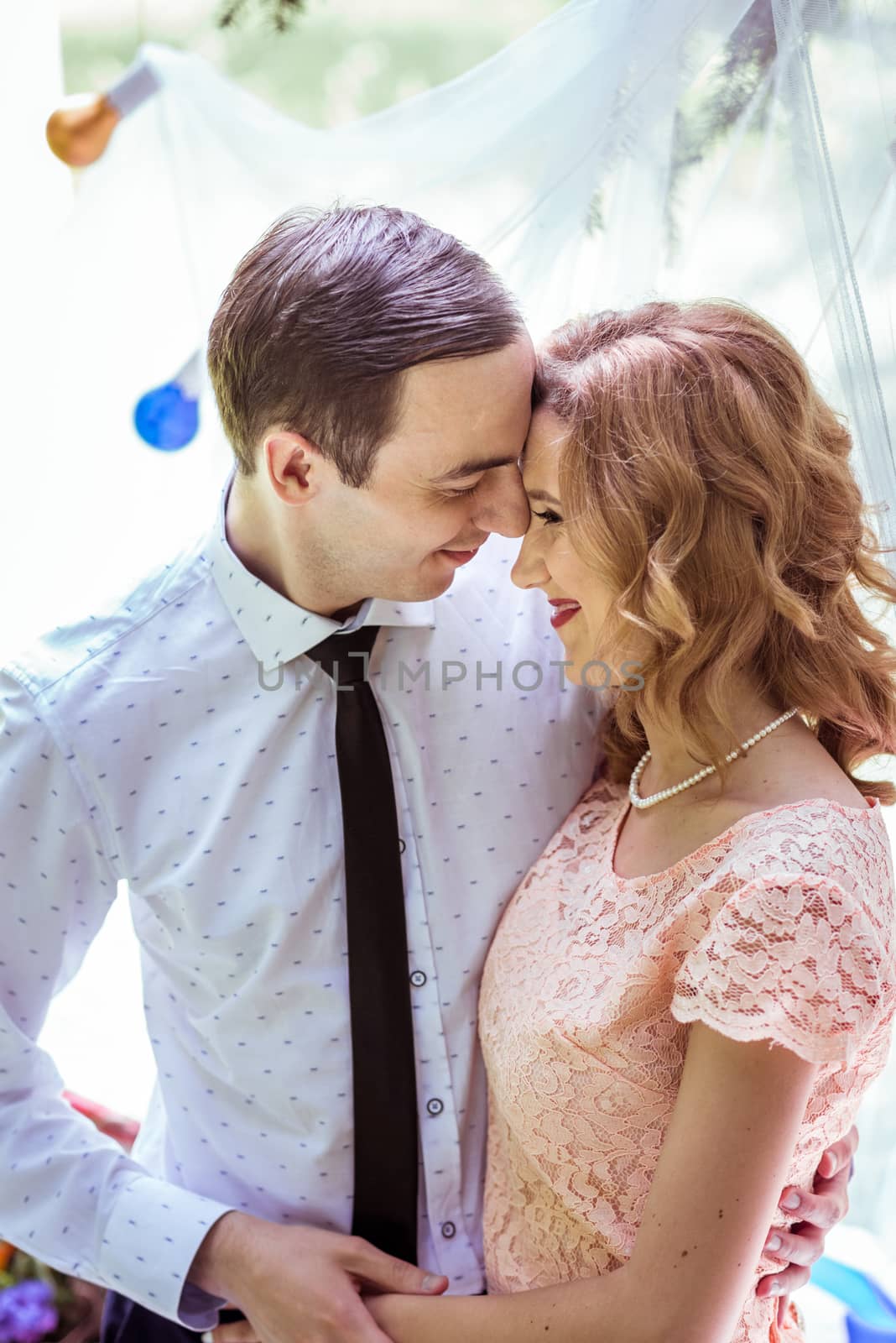 Close up portrait of couple. Smiling man and woman embracing in Lviv, Ukraine.