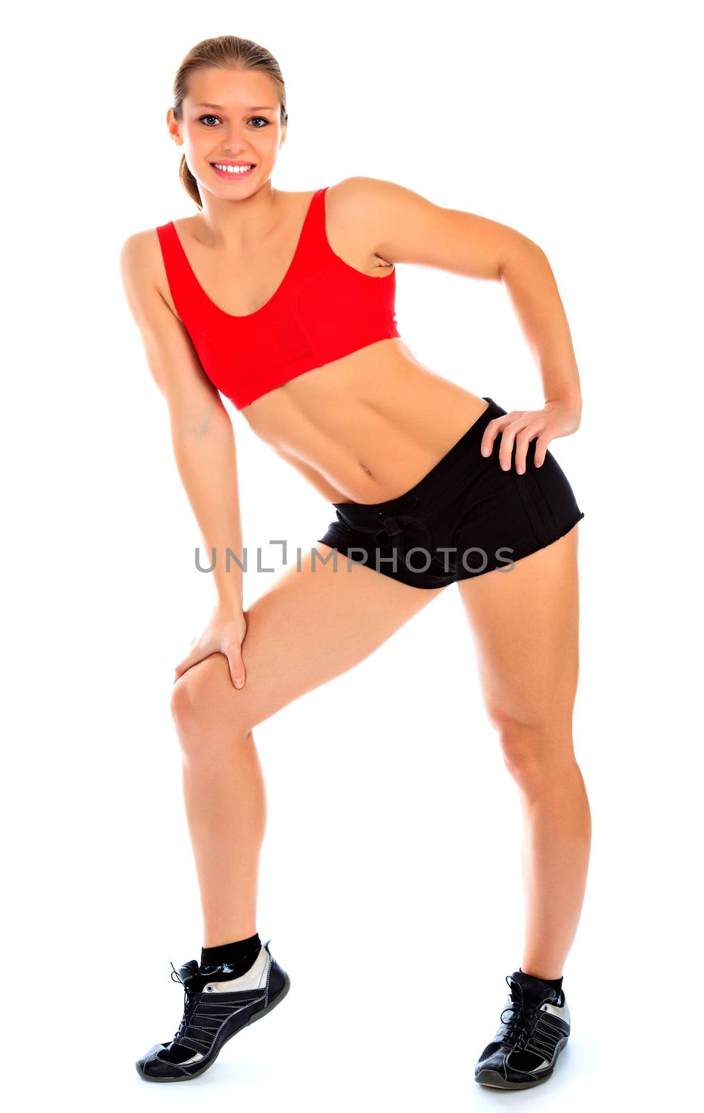 Fitness woman posing against a white background, isolated